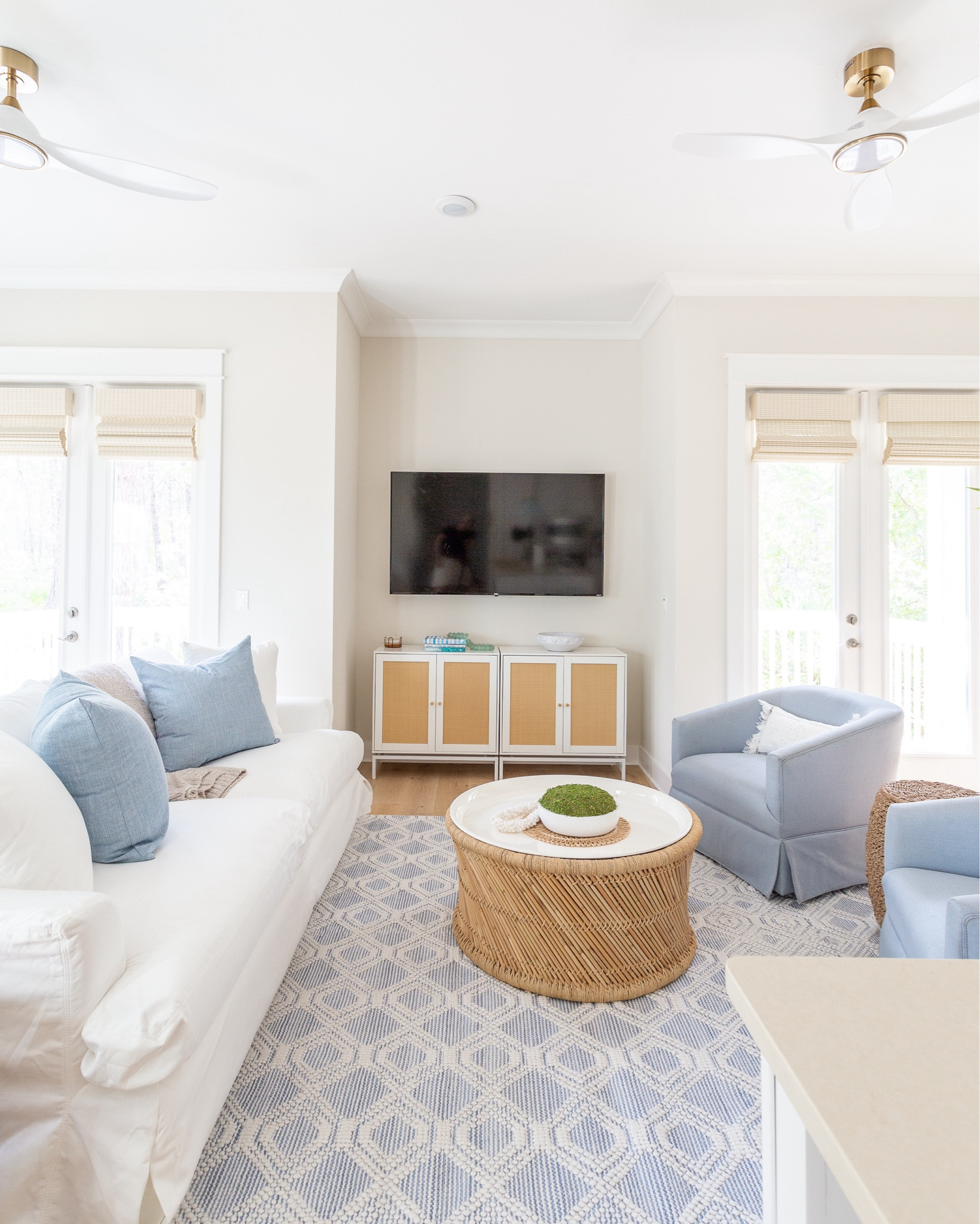 The living room at Hola Beaches Casita, our latest 30A vacation rental, has so many great designer looks for less! This slipcovered sofa is fully washable. These light blue swivel armchairs, woven blue rug, bamboo storage coffee table, rattan style media cabinet and white and gold ceiling fan all add the perfect coastal vibes! See more pics and take the full home tour here: https://lifeonvirginiastreet.com/hola-beaches-casita-30a-tour/.
.
#ltkhome #ltksalealert #ltkseasonal #ltkstyletip #ltkfindsunder50 #ltkfindsunder100 #ltktravel

#LTKHome #LTKSaleAlert #LTKxWalmart