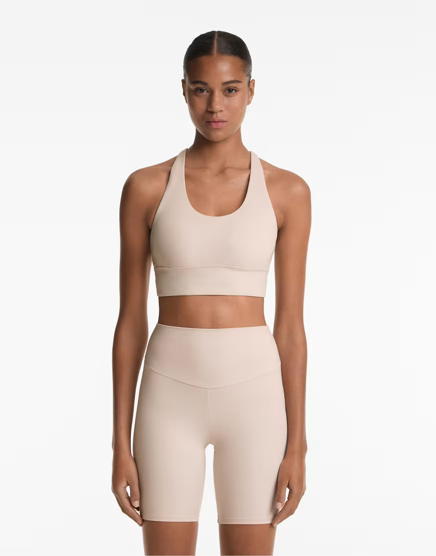 OYSHO Medium-support comfortlux sports bra with cups in mink-Pink | ASOS (Global)
