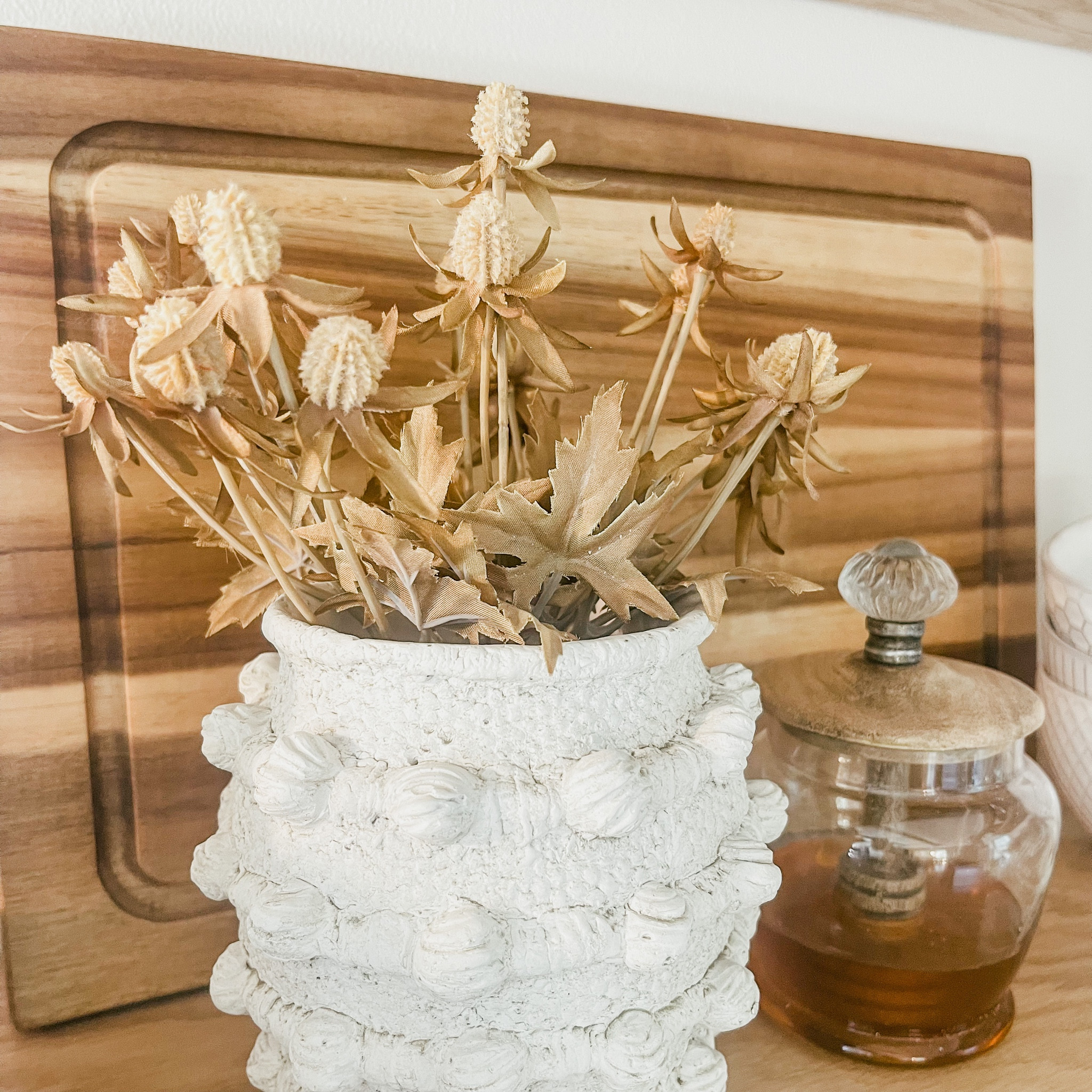 I am in LOVE with this minka pot from Anthropology for a long time, and I’m so glad that I made the investment! It’s a solid piece, and definitely one that can go from season to season. I filled it with these pretty fall stems, and added this pretty little honey jar from Mud Pie. I love honey in my tea, especially during the cold months when all the sniffles tend to come! I love how all of these pieces add some cool texture variation to my neutral decor. 🤍

#LTKSeasonal #LTKhome