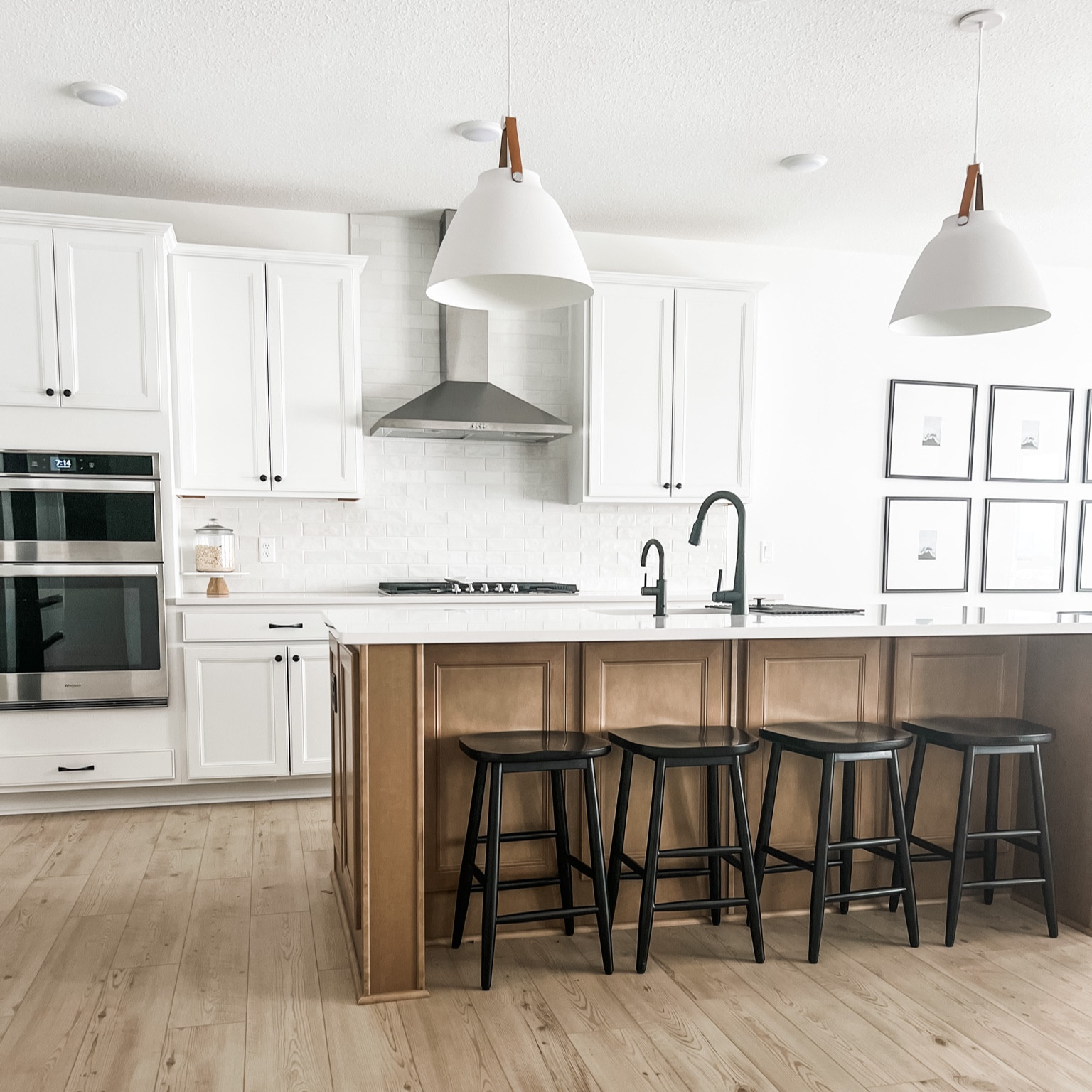 My kitchen. Kitchen decor, pendant lights, chandelier, gallery wall. Dinning room, living room, bar stools, white cabinets, LVP, white oak, modern kitchen, backsplash, subway tile, glass tile, fridge. 

#LTKunder50 #LTKhome #LTKunder100