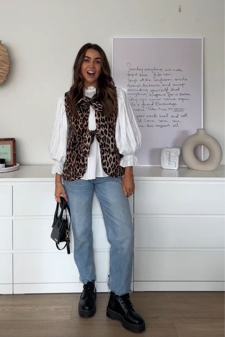 Styling the damson madder leopard print gilet with a floaty white shirt and blue denim jeans, teamed with dr marten Jadon boots 