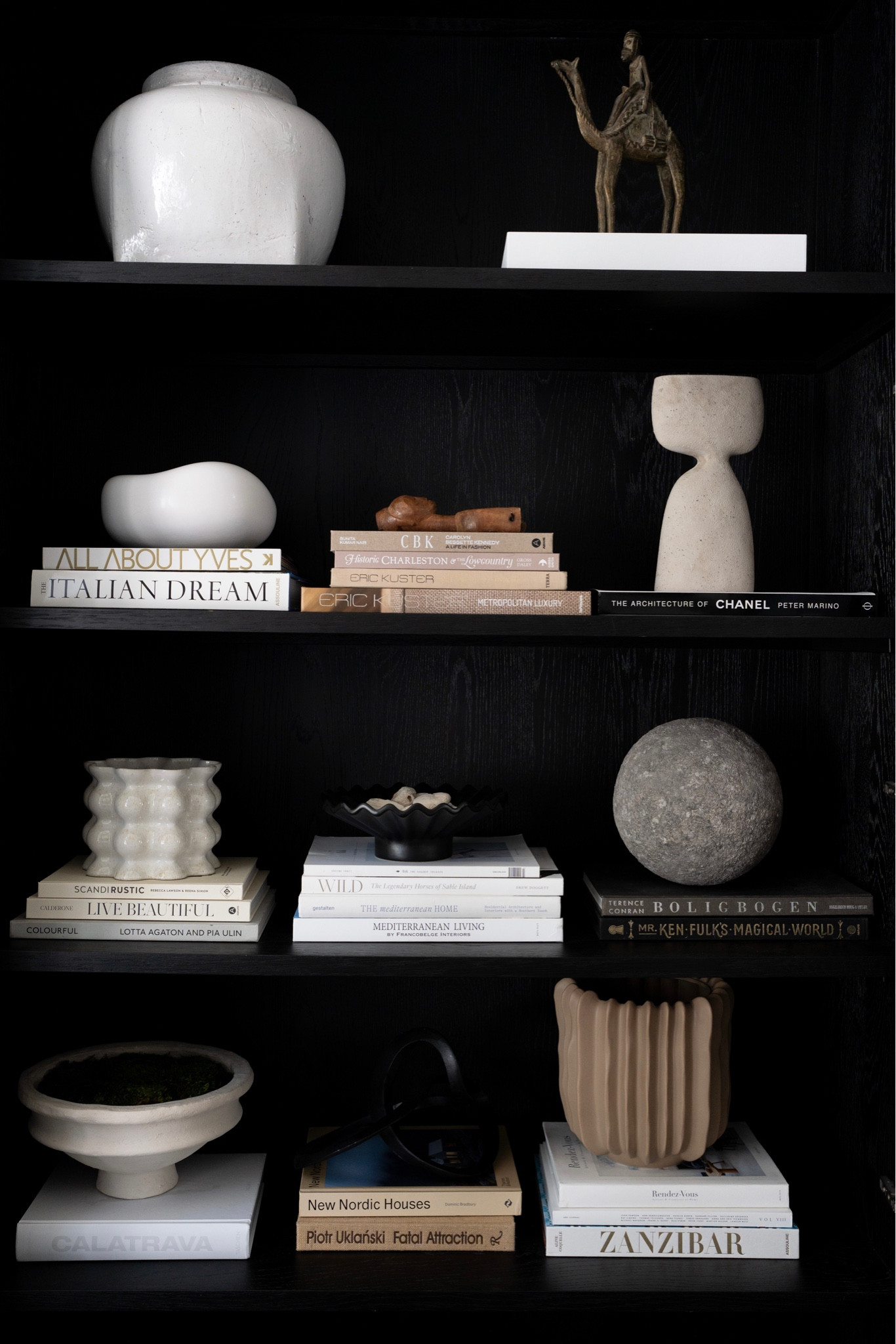 Using a harmonious grouping and color palette brings unity to the overall look of your bookcases!
