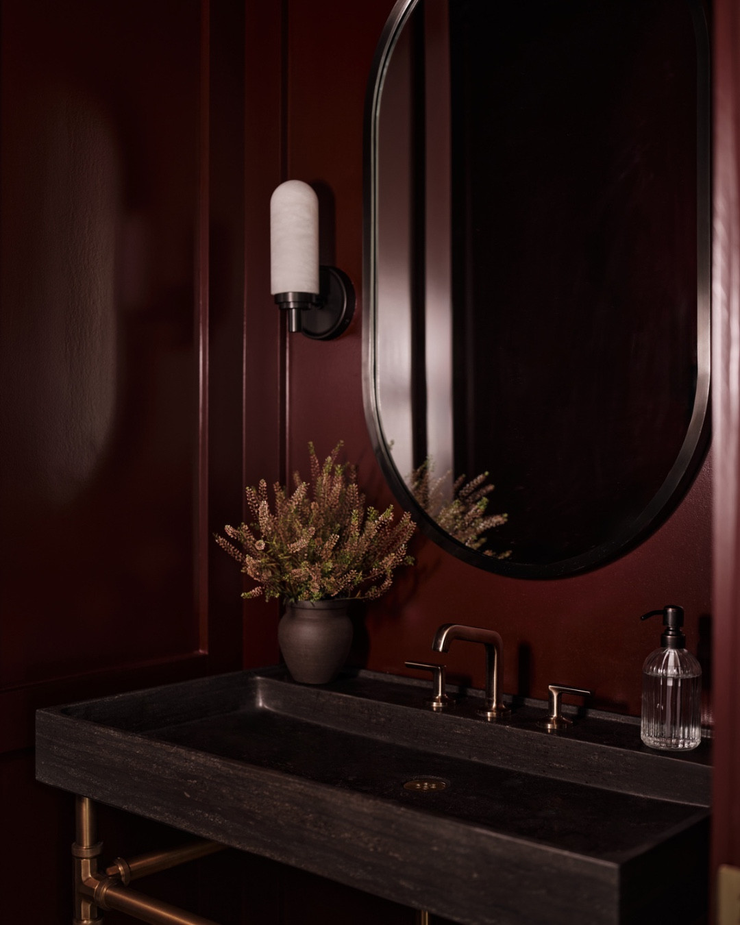 A small powder room is the best excuse to create a dark and moody moment. 