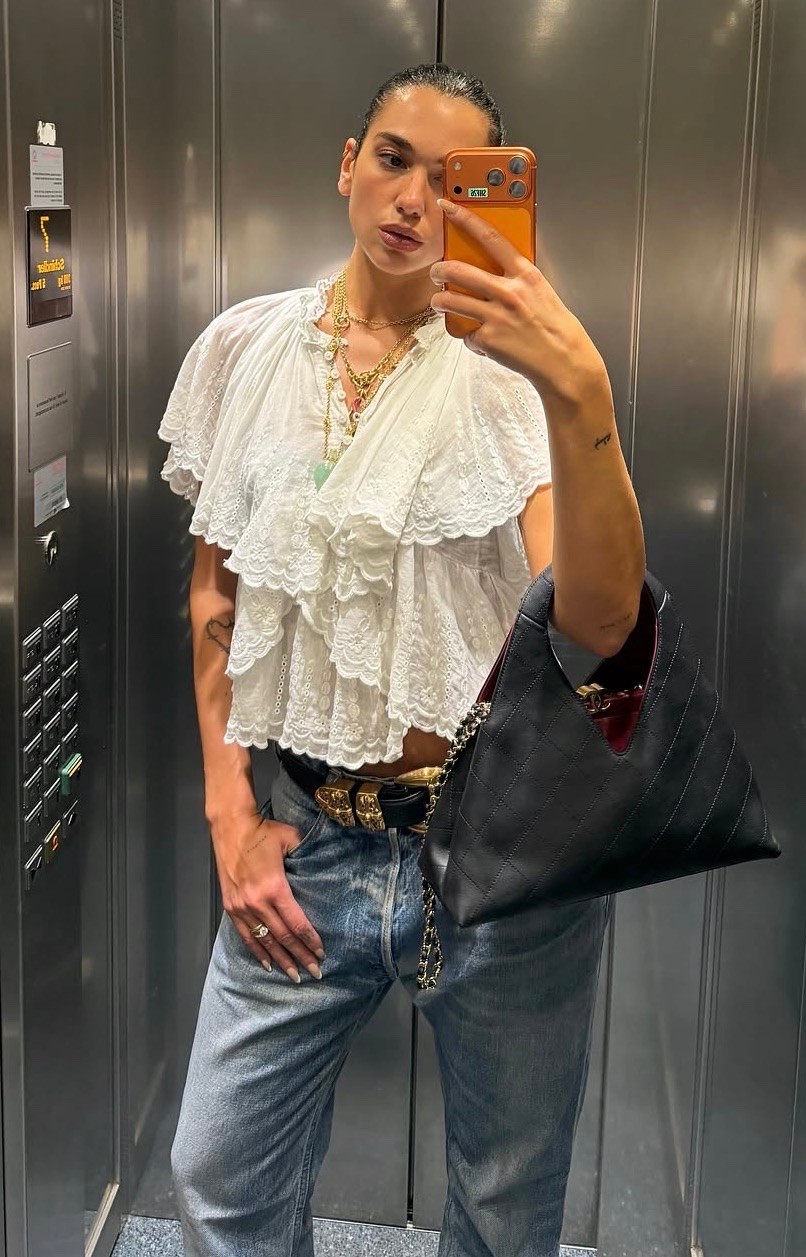 Dua Lipa white ruffle front short sleeve eyelet blouse vintage Levi's jeans ￼