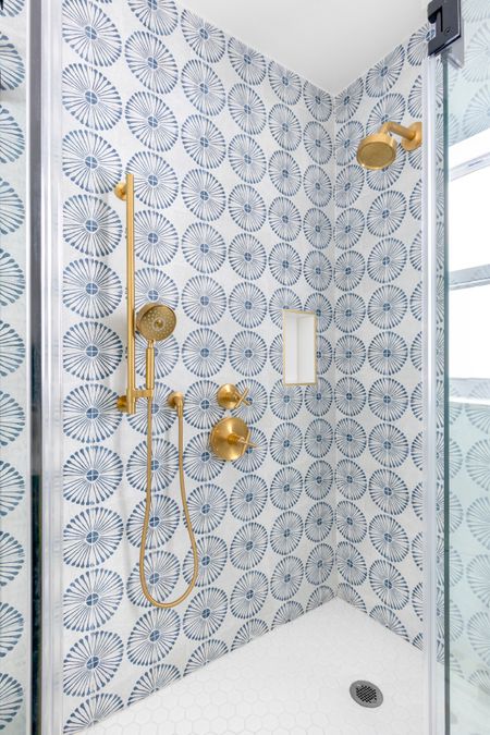 This kid’s bath is a fun and lively space that sparks joy and creativity. The shower wall is adorned with sunburst-shaped blue tiles, adding a touch of whimsy and energy. #subwaytile #bluebathroom #kidsbath #kidsbathroom #moroccanthemebath #moroccaninspireddesign #interiordesign #brassfixtures 

#LTKHome #LTKKids
