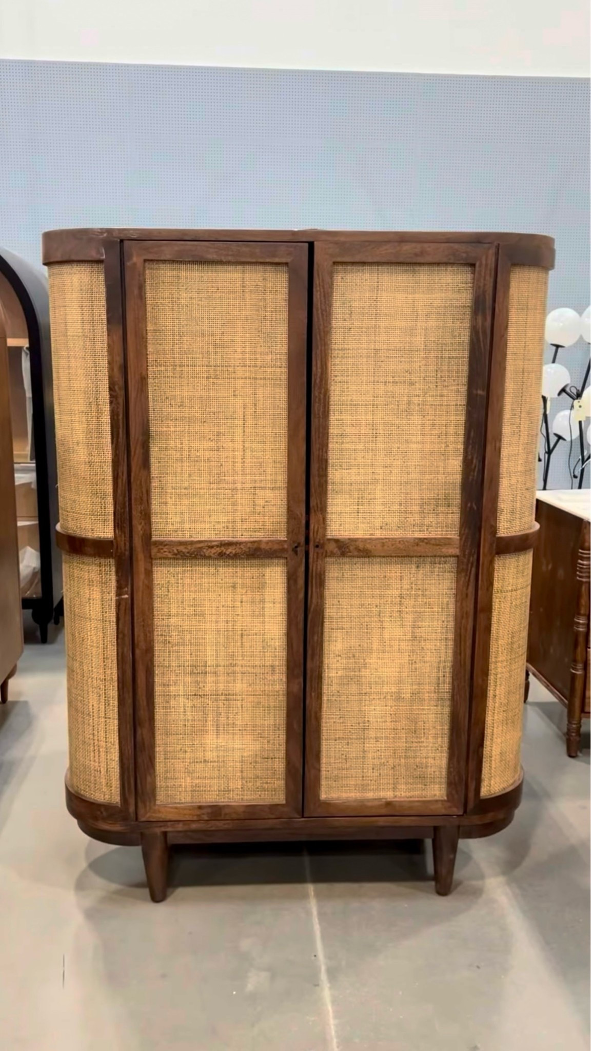 A gorgeous statement cabinet! 🤎 The Daphne Cabinet pairs rich dark acacia wood with woven cane rattan for the perfect mix of mid-century warmth and organic texture. 🌾 Its tall silhouette and roomy storage make it beautiful for a dining room, living space, or entryway while adding that elevated designer feel. ✨ Linked this cabinet and similar woven storage pieces! 🙌🏻 #StorageCabinet #FurnitureFind #BohoHome

#LTKHome #LTKSaleAlert