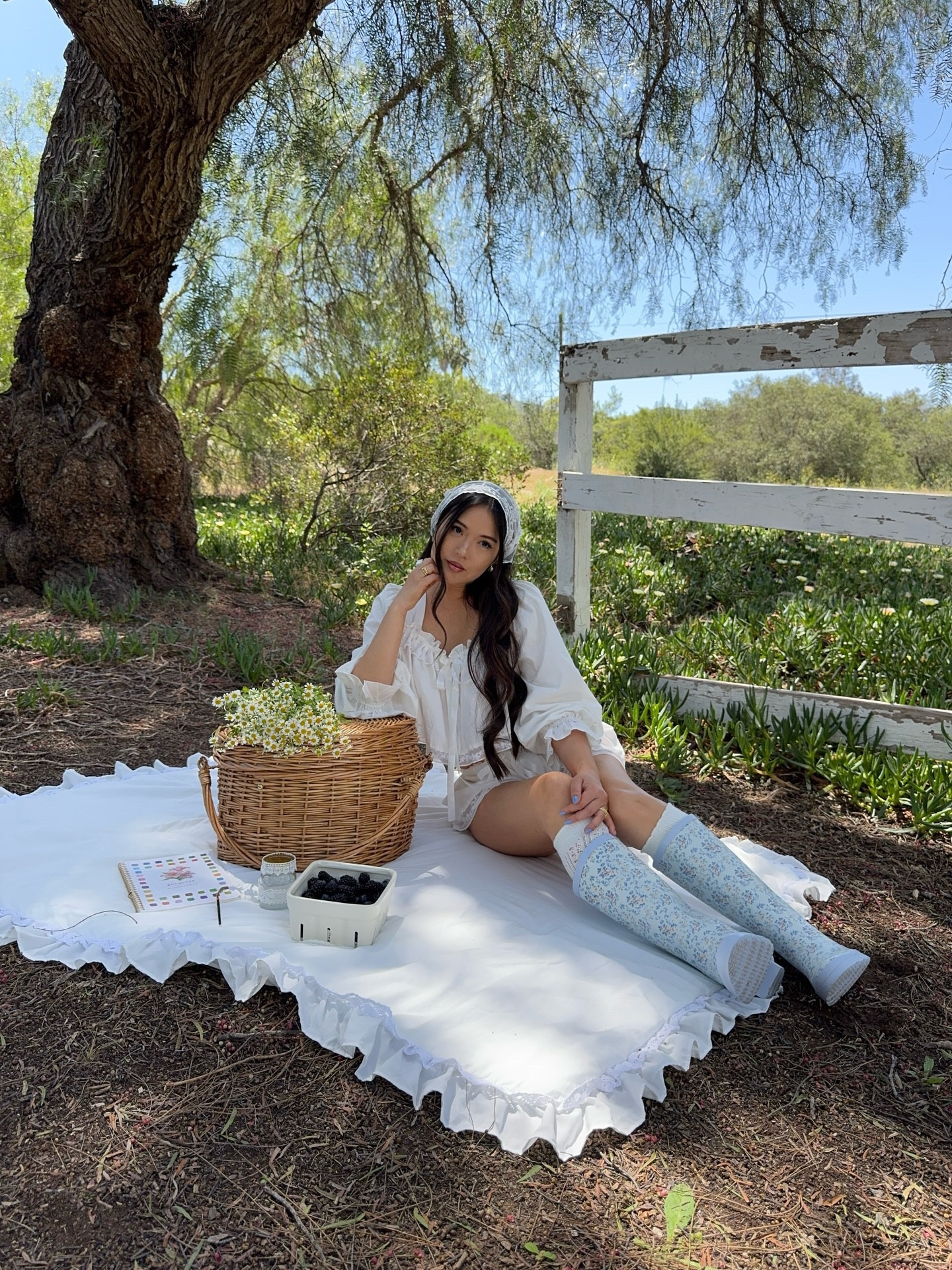 Picnic season is here 🧺🫐🌿
.
.
.
.
spring ootd, whimsy outfit ideas, whimsical fashion inspo, cottagecore outfits, floral rain boots, for love and lemons, white linen set, how to style a hair scarf this summer #spring #pinterestaesthetic #outfitideas