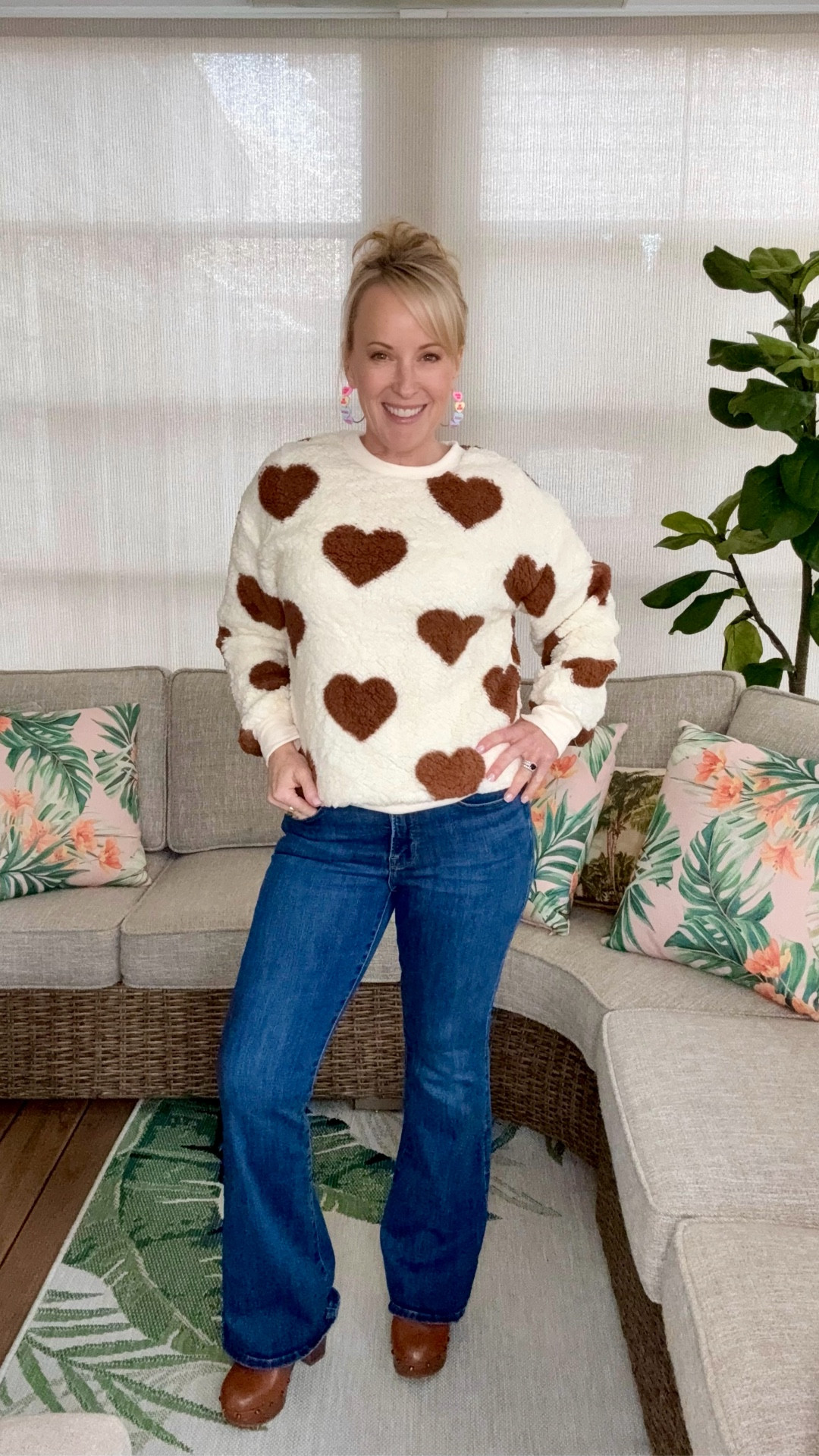 This brown heart sweatshirt has quickly become one of my favorites - it’s so soft and feels like you’re wearing a blanket while still looking put together! 🤎 I paired it with my go-to Jessica Simpson wide-leg jeans and my favorite heeled clogs. All of these items are from Walmart and are available at a great price! My clogs are unfortunately sold out but I’ve linked a few other similar options. I topped this outfit off with these cute conversation heart earrings from Amazon that I keep getting compliments on and  add a festive pop to any look. Shop these pieces for an easy, comfy outfit that’s perfect for Valentine’s Day! ✨

#LTKFindsUnder50 #LTKootd #LTKPetite