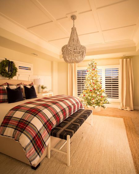 We love the glow of the Christmas tree at night in our master bedroom decorated for Christmas! Items include plaid bedding and shams, blue velvet pillows, faux wreath with blue ribbon, king sized upholstered wingback bed, large wood beaded chandelier, striped linen curtains, blue and natural wicker bench, white nightstand with cane inset doors and a simple white and tan jute area rug.

Christmas décor, Christmas bedroom, stewart plaid, Christmas pillows, bedroom bench, target bed, pottery barn bedding, faux Christmas tree, rug on carpet, bedroom area rug, tree collar, #ltkholiday #ltkfamily 

#LTKSeasonal #LTKstyletip #LTKunder50 #LTKunder100 #LTKhome #LTKsalealert #LTKstyletip #LTKSeasonal #LTKHoliday