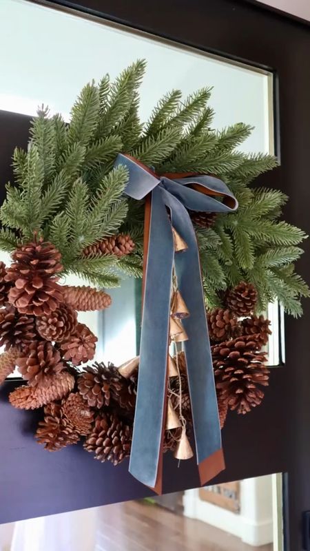 This Walmart wreath is under $30 and beautiful! 

BUT, I wanted to really make it stand out, and here is how!

1- remove the brown ribbon and iron or steam. 

2- cut the same length velvet pewter colored ribbon and re-attach in a pretty bow. 

3- hang brass bells from the center and hang! 

#LTKfindsunder50 #LTKHoliday #LTKhome