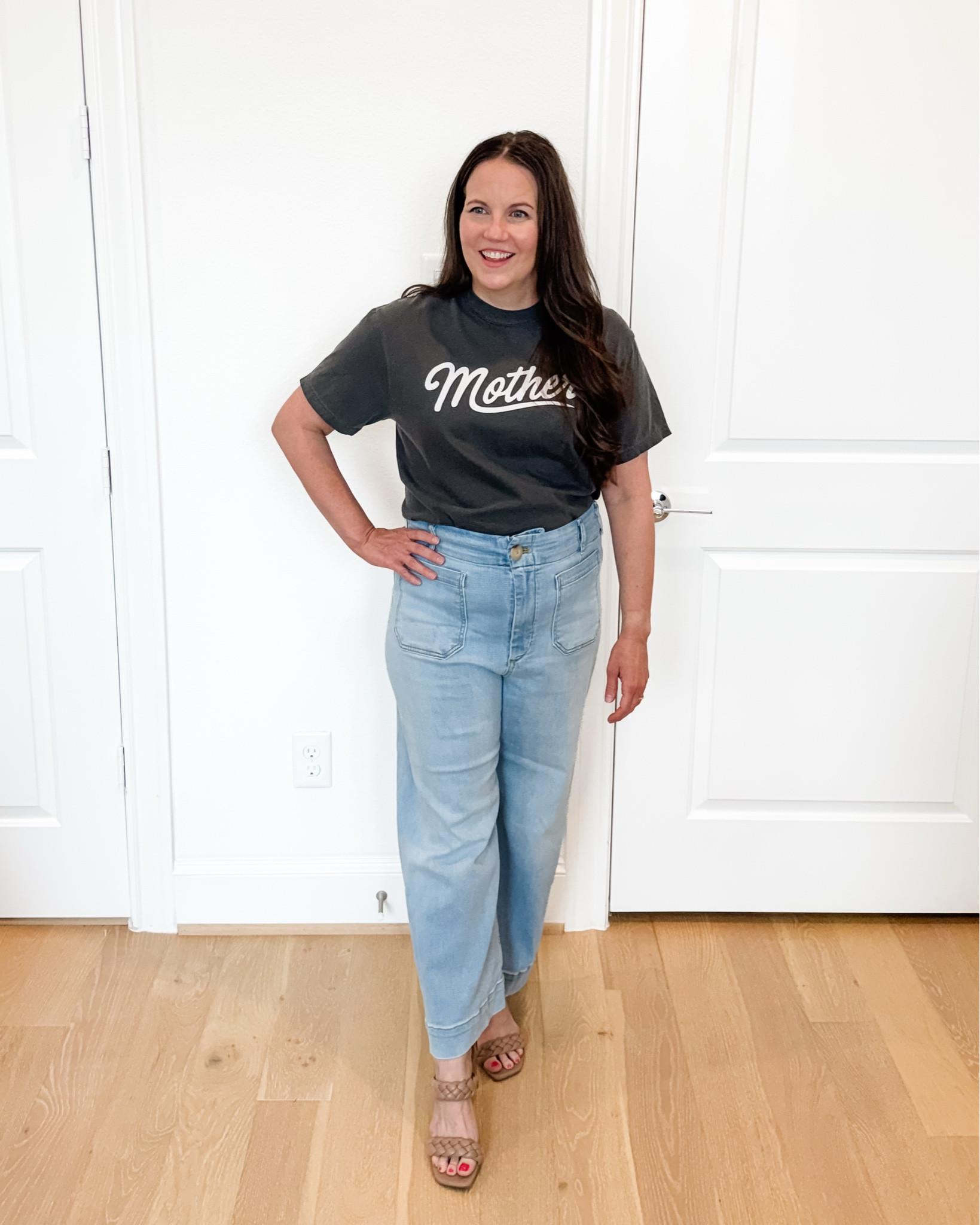 This casual chic and easy mom outfit pairs a dark gray mother graphic tee with light wash flared jeans and braided sandals for a look that feels comfortable, elevated, and effortless. These jeans with stretch are incredibly flattering and perfect for everyday wear, while the graphic tee is one of my favorite mom shirts for adding personality to a simple outfit. Whether you’re heading out for lunch, running errands, traveling, or packing a vacation outfit, this classic combination is a staple for creating stylish summer outfits you’ll wear on repeat.

#LTKmomlife #LTKootd #LTKSeasonal