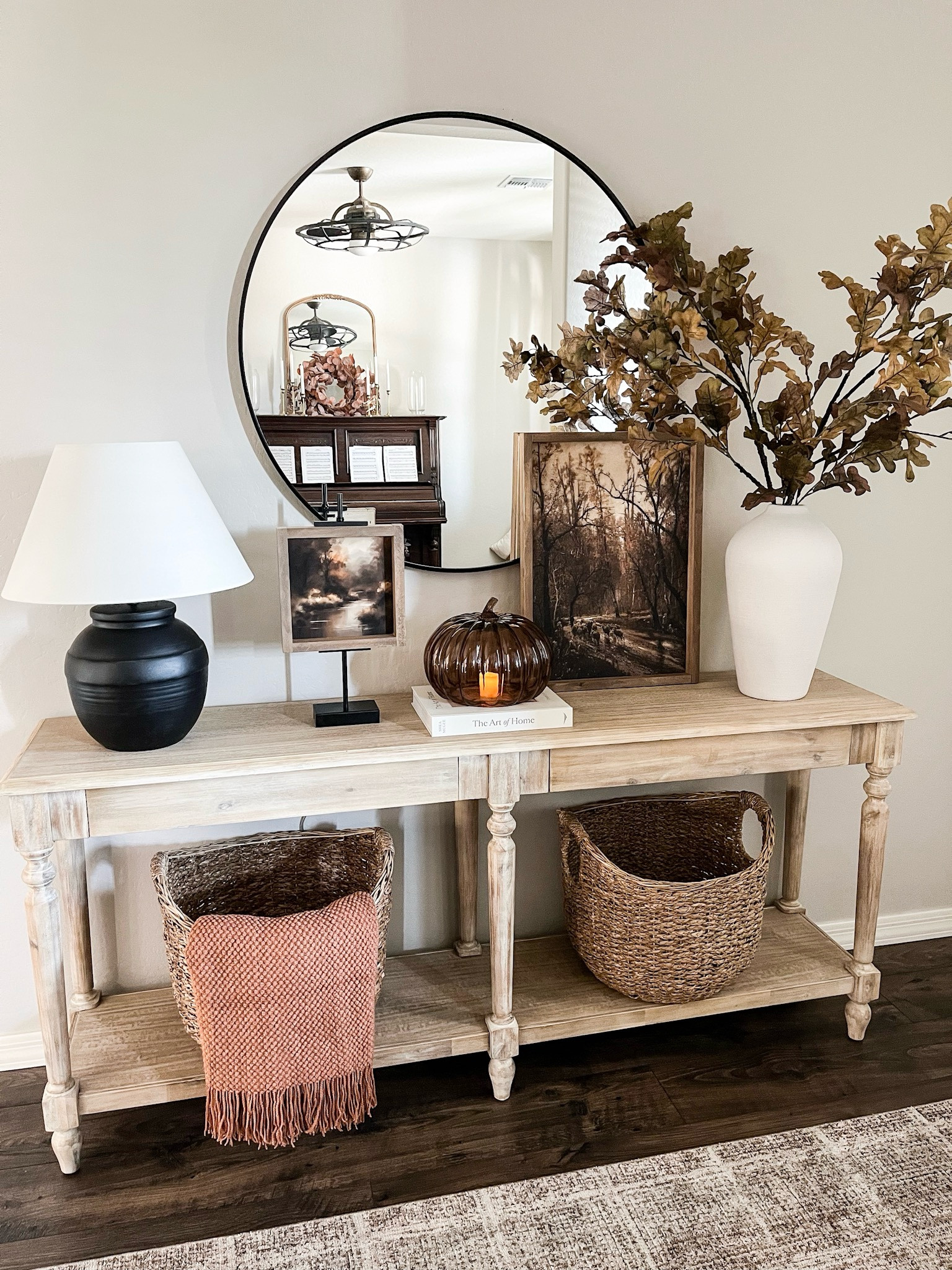 Style with me: FALL
CONSOLE TABLE!  Follow
@lifeinmyarizonahome
on Instagram for more inspiration.

My front entryway is all ready for fall with these beautiful stems and vase, artwork, and glass amber pumpkin. I added a flameless candle for that cozy vibe. My console table is probably one of my favorite areas to style and it's on major sale right now.
For reference the sheep on an autumn path canvas is in the 16x22 size and the canvas in the easel is in the 9x9 size both with the briarsmoke stain.

#falldecor
#consoletablestyling #homedecor

#LTKSeasonal #LTKSaleAlert #LTKHome