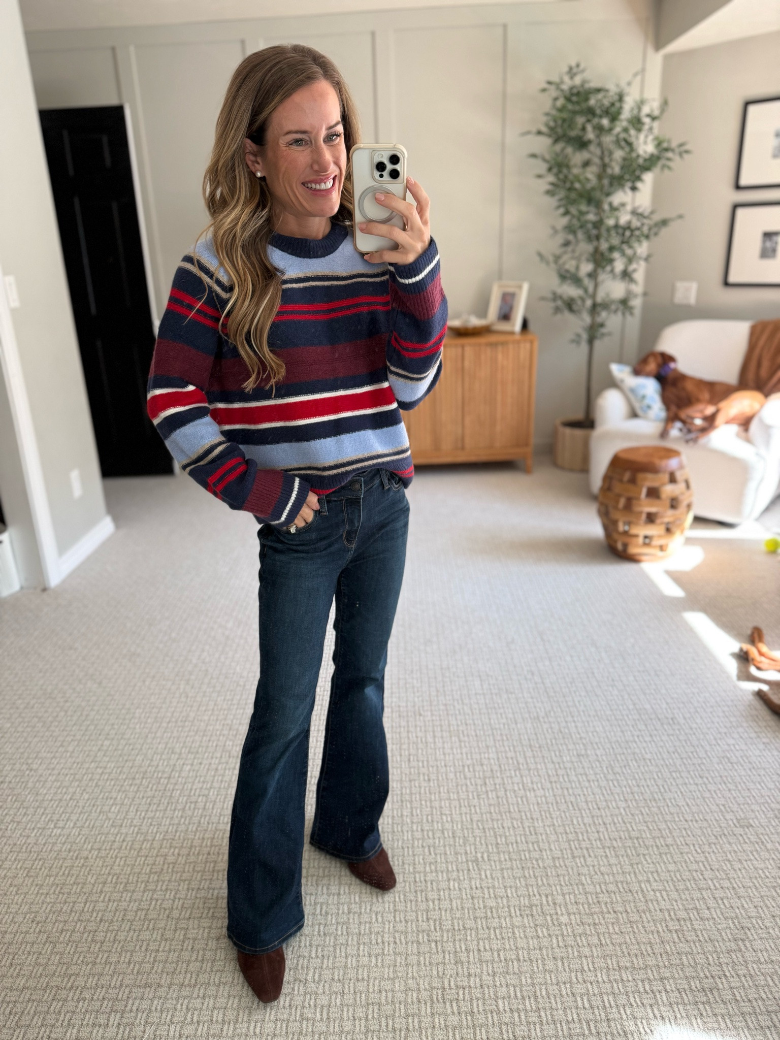 A fitted sweater and flared jeans bring easy style to the room. Layer a neutral boot for comfort.