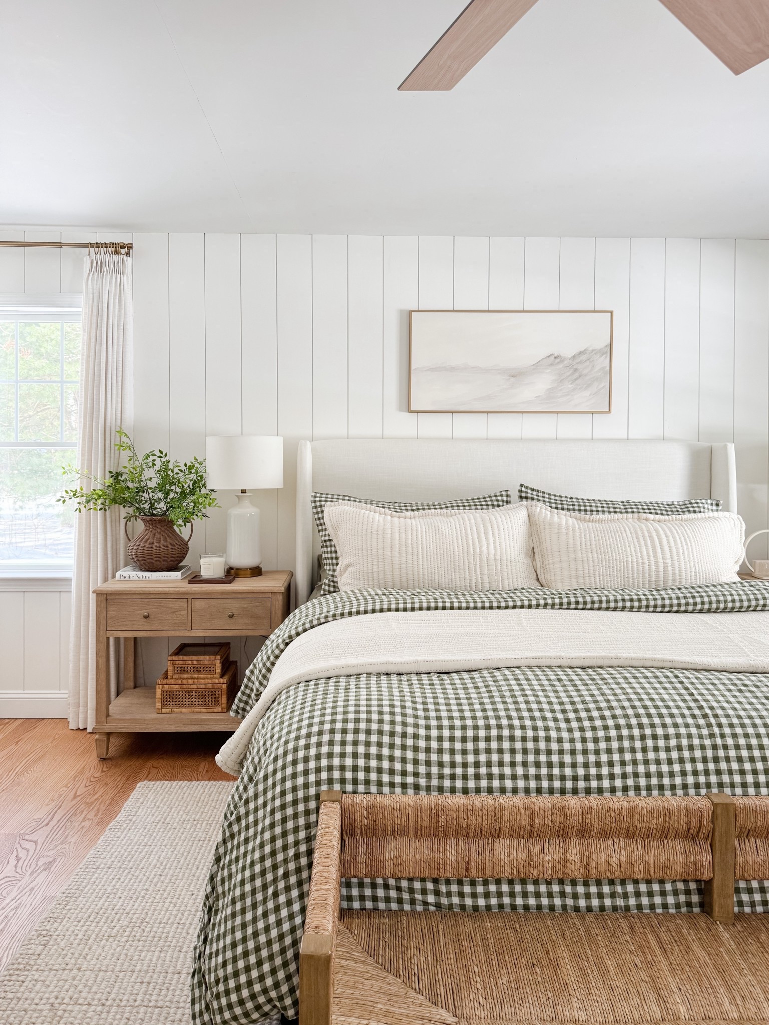 Neutral coastal bedroom with gingham bedding, layered throw blankets, textured knit coverlet, and soft patterned pillows. Light wood nightstands and white table lamps create a calm, layered spring bedroom look. 
gingham bedding, neutral bedroom decor, layered bedding, spring bedding, coastal bedroom, throw blanket, knit coverlet, patterned pillows, light wood nightstands, white table lamps, cozy bedroom, serene bedroom style, sherri calnan home

#LTKHome