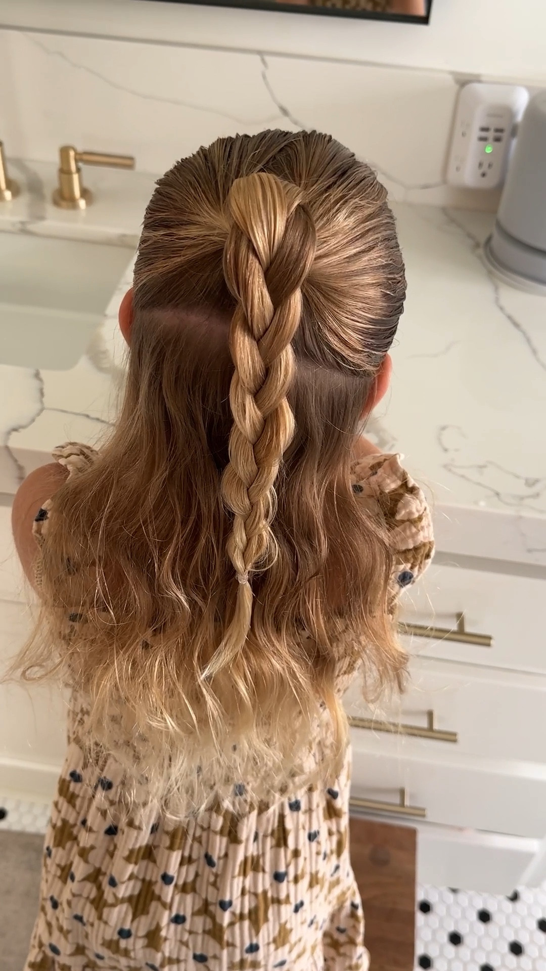 A topsy tail flipped half up braid 