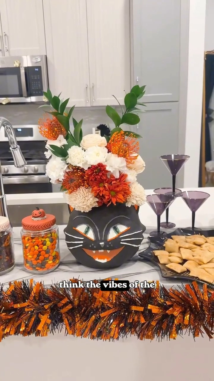 These vintage Halloween heads might not exactly be waterproof…

But they’re not the Wicked Witch of the West either

Well… with the help of an XL mason jar, filler paper + floral foam that is 

I grabbed a few matching bouquets from Trader Joe’s and despite having zero floral arranging talent I LOVE how it turned out

SUPER cute for a Halloween party centetpiece or just your regular October tablescape

And once the flowers are done? Candy bowl.😉

*Comment VASE and I’ll send you the vintage Halloween heads, exact mason jar + the coupon code I used 💌
•
•
•
#halloweendecor #halloweendiy #vintagehalloween vintage Halloween decor, Halloween centerpiece, Halloween tablescape, vintage halloween party