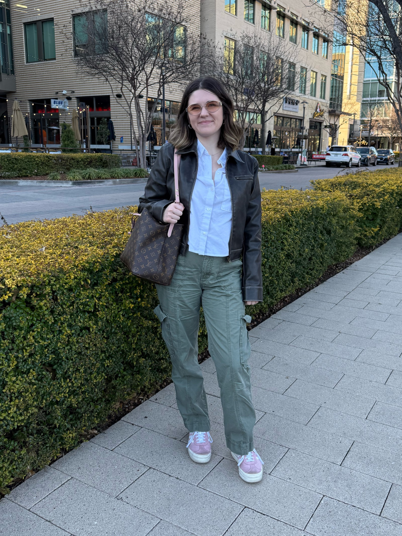 Daily outfit 
Abercrombie cropped button down shirt 
Revolve Leather Jacket
Abercrombie cargo pants 
Pink Adidas Gazelles 
Louis Vuitton purse 
Amazon glasses 

#LTKStyleTip #LTKShoeCrush