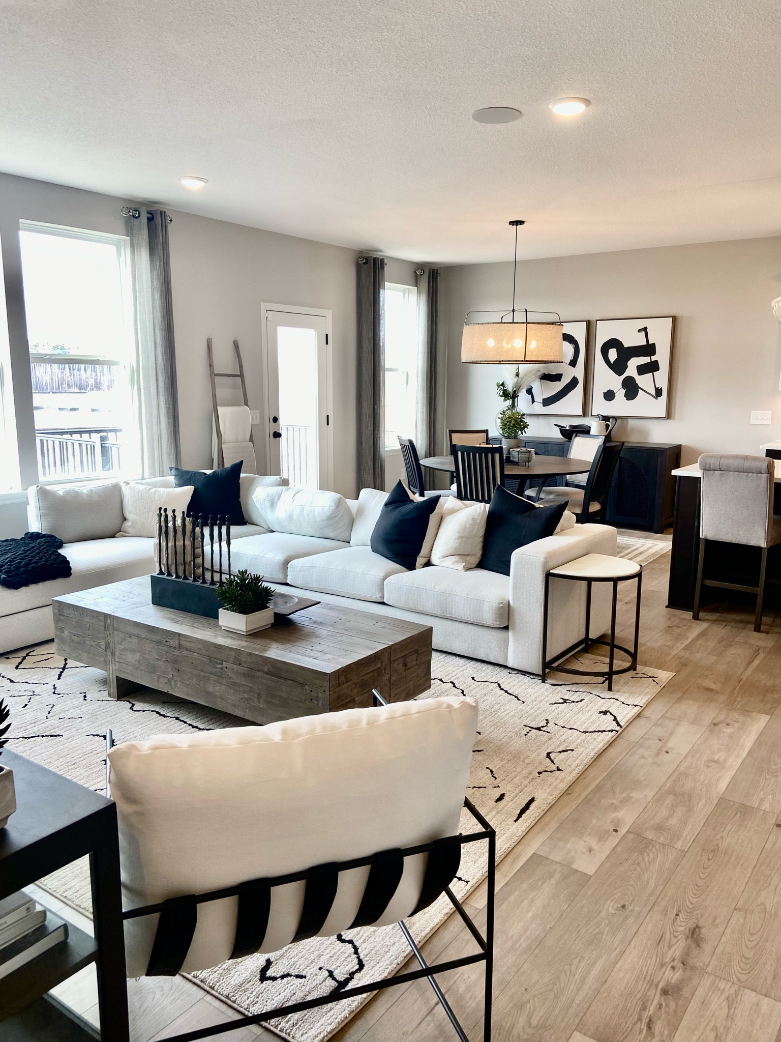 Modern living room, black accents and decor, couch, sofa, art work, chandelier, pendants, side tables, sideboard, credenza, Buffett, cabinet, accent chair, coffee table, west elm, burke decor, wayfair, Target.

#LTKstyletip #LTKhome #LTKsalealert