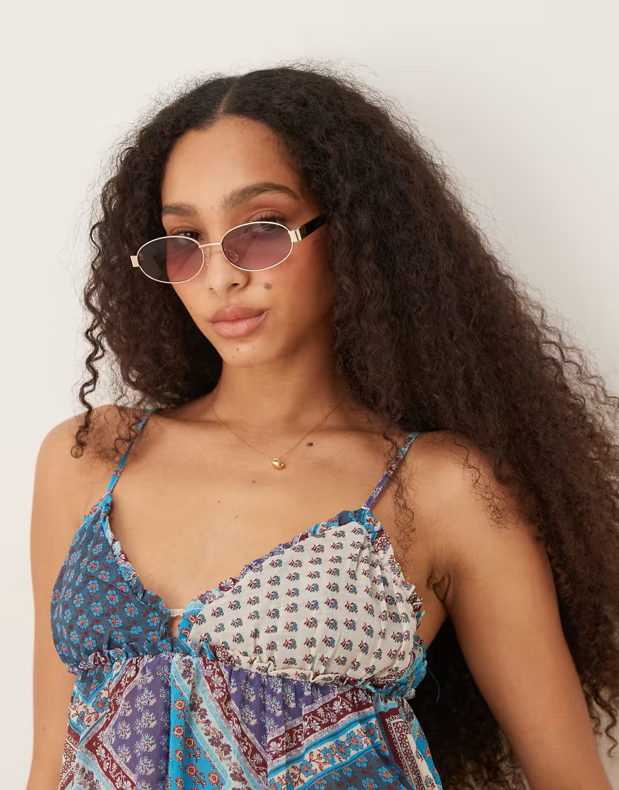 ASOS DEISGN metal oval sunglasses in gold with black arms | ASOS (Global)