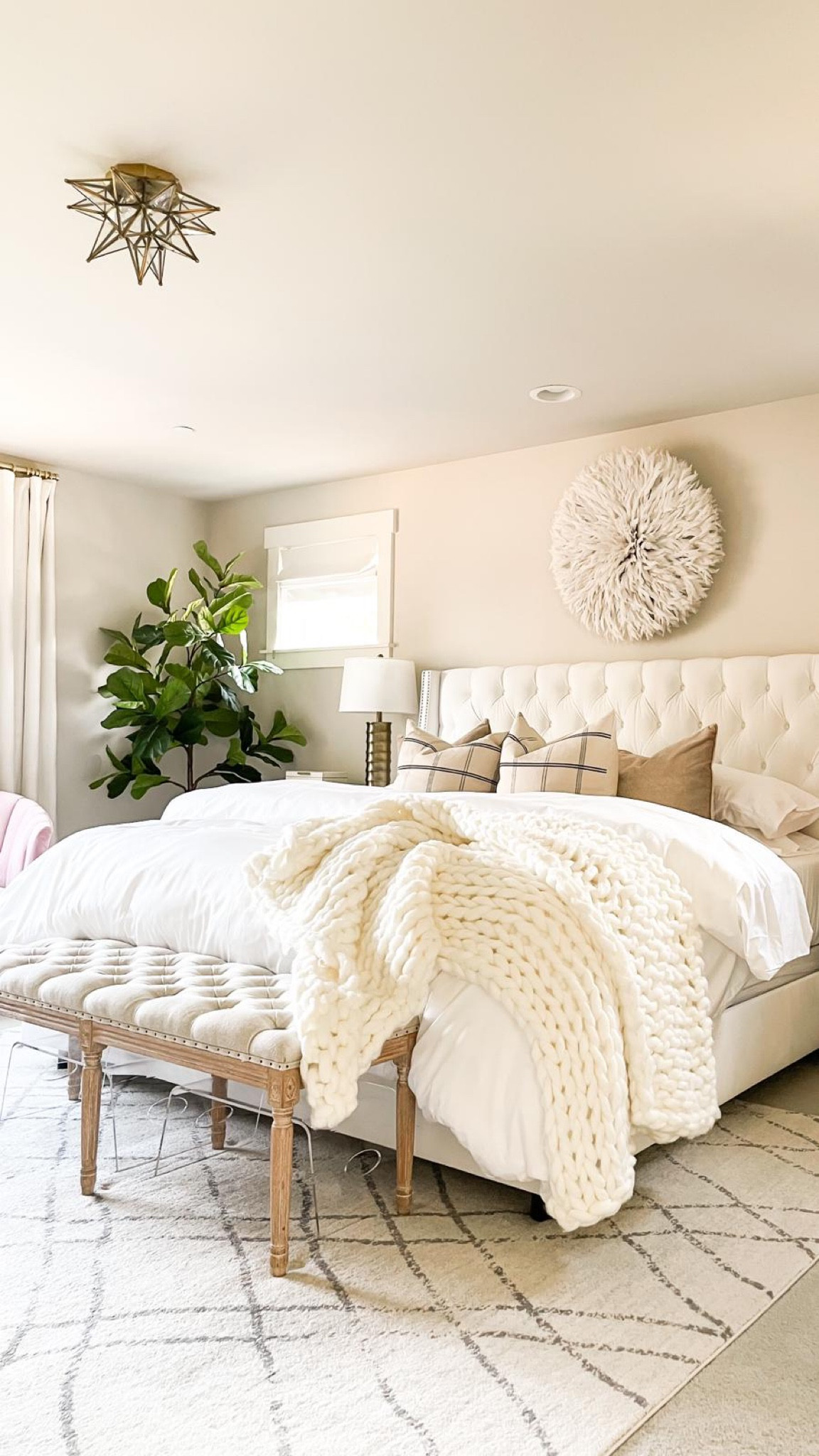 Neutral primary bedroom decor, juju hat, white tufted bed frame, wooden bench, chunky knit throw, faux fiddle leaf tree

#LTKhome #LTKfindsunder100