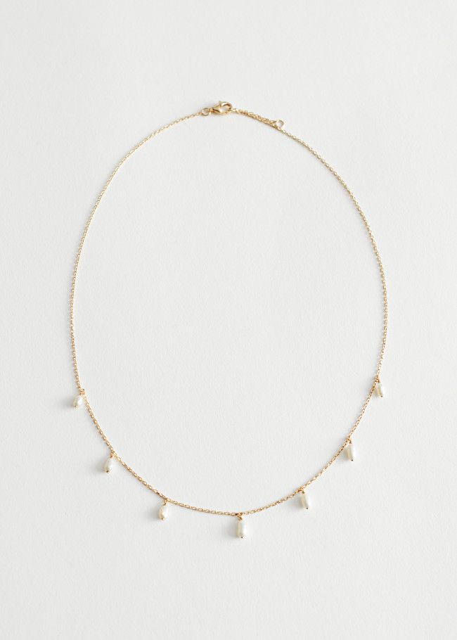 Gold-toned chain link necklace featuring seven freshwater pearl charms. | & Other Stories (EU + UK)