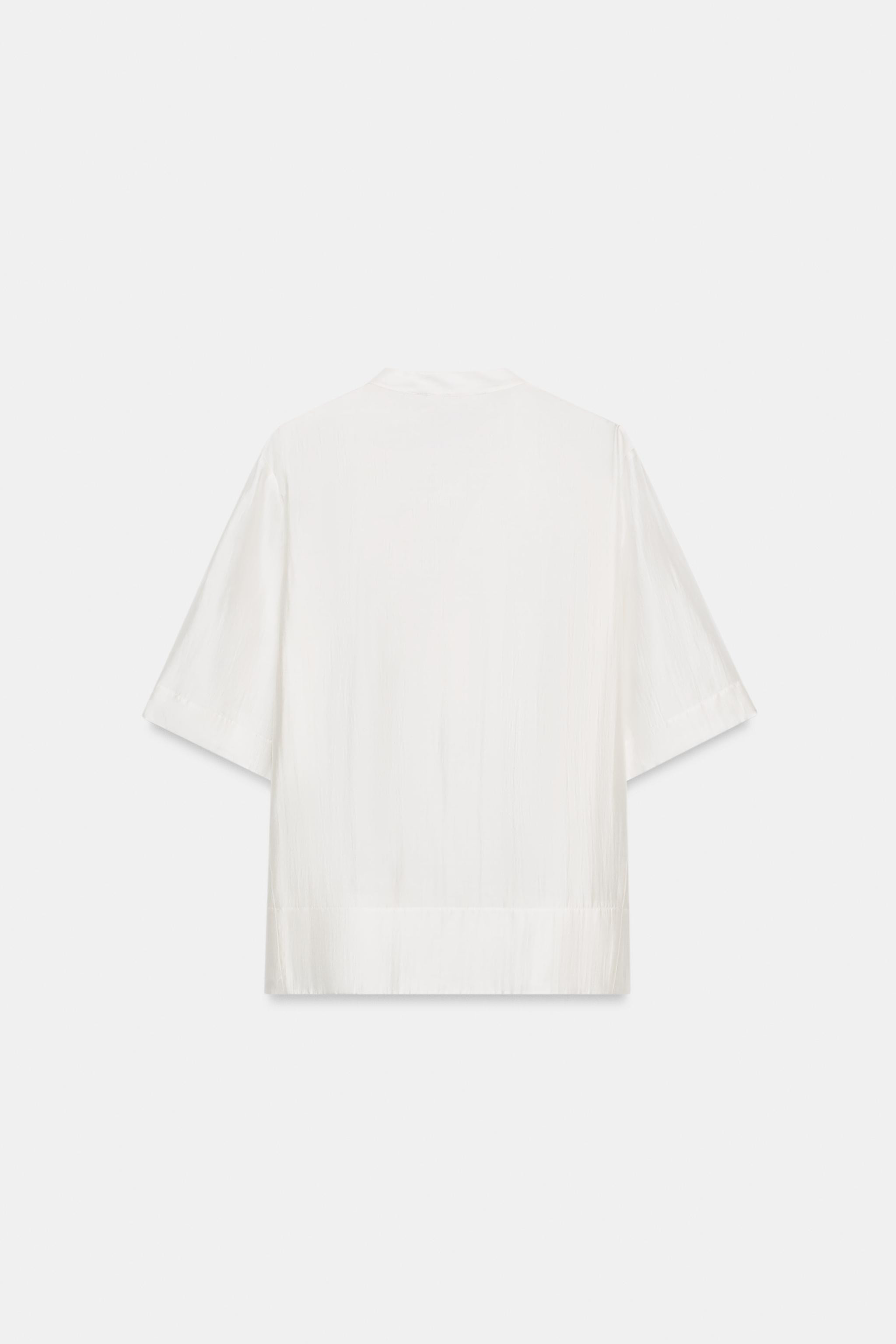 ZARA WOMAN COLLECTIONBlouse made of a lyocell blend yarn. Round neck and short sleeves. Straight ... | Zara Canada