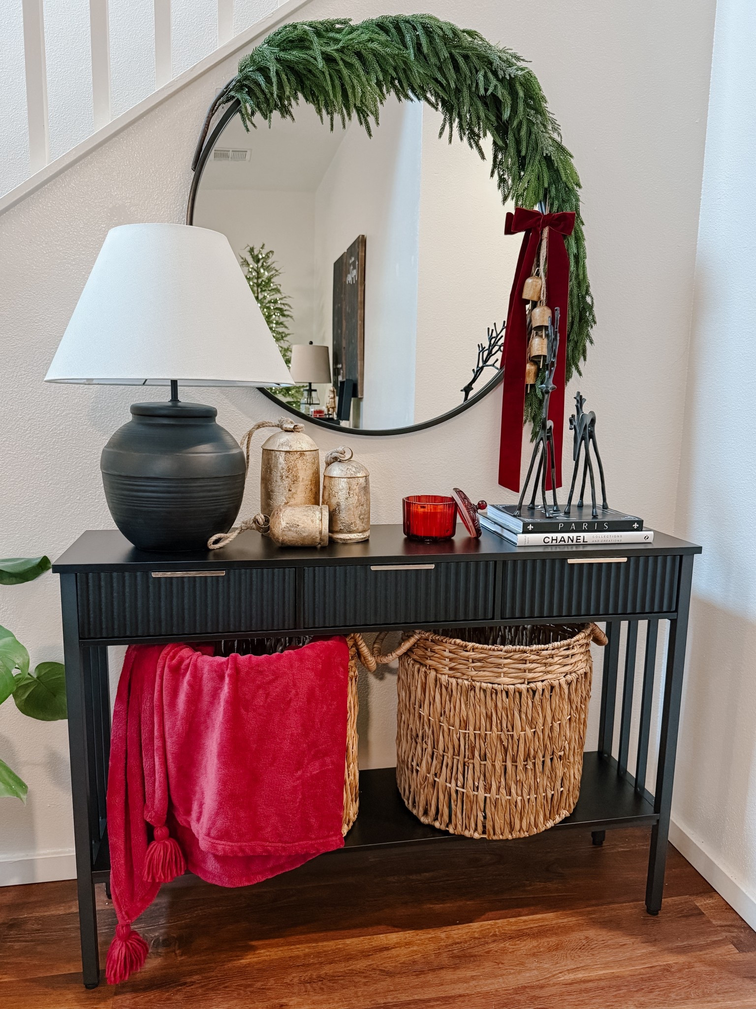 A little Christmas magic by the entryway✨

I added a cedar garland around the mirror and tied it with bells and a bow for that timeless holiday touch. The black reindeer from @walmart, a cozy @target candle, and gold bells from @amazonprime bring in the perfect mix of classic and modern Christmas decor.

I love how a few simple pieces can completely transform a space — soft lights, warm textures, and a touch of Christmas glow make everything feel so cozy. 🤎

#LTKHoliday #LTKHome #LTKSeasonal