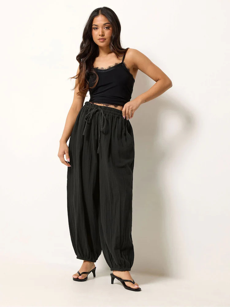 PixieGirl Petite Black Cheesecloth Balloon Trousers | Next US