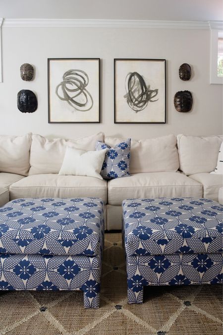 Big u-shaped sectional, blue and white square upholsterer ottomans, circle art

#LTKhome