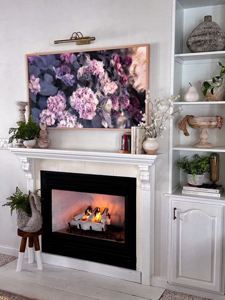 Frame tv art and faux fireplace logs 

#LTKhome