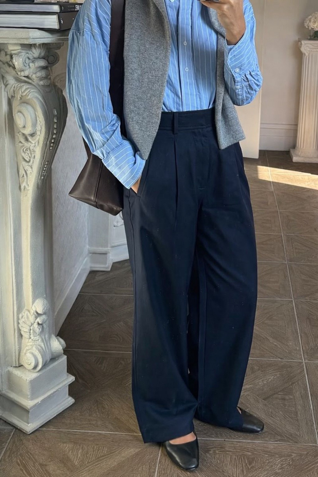 Office outfit idea: navy blue pants, light blue striped button up, tote bag, Mary Jane flats, and a draped cashmere sweater 

#LTKWorkwear