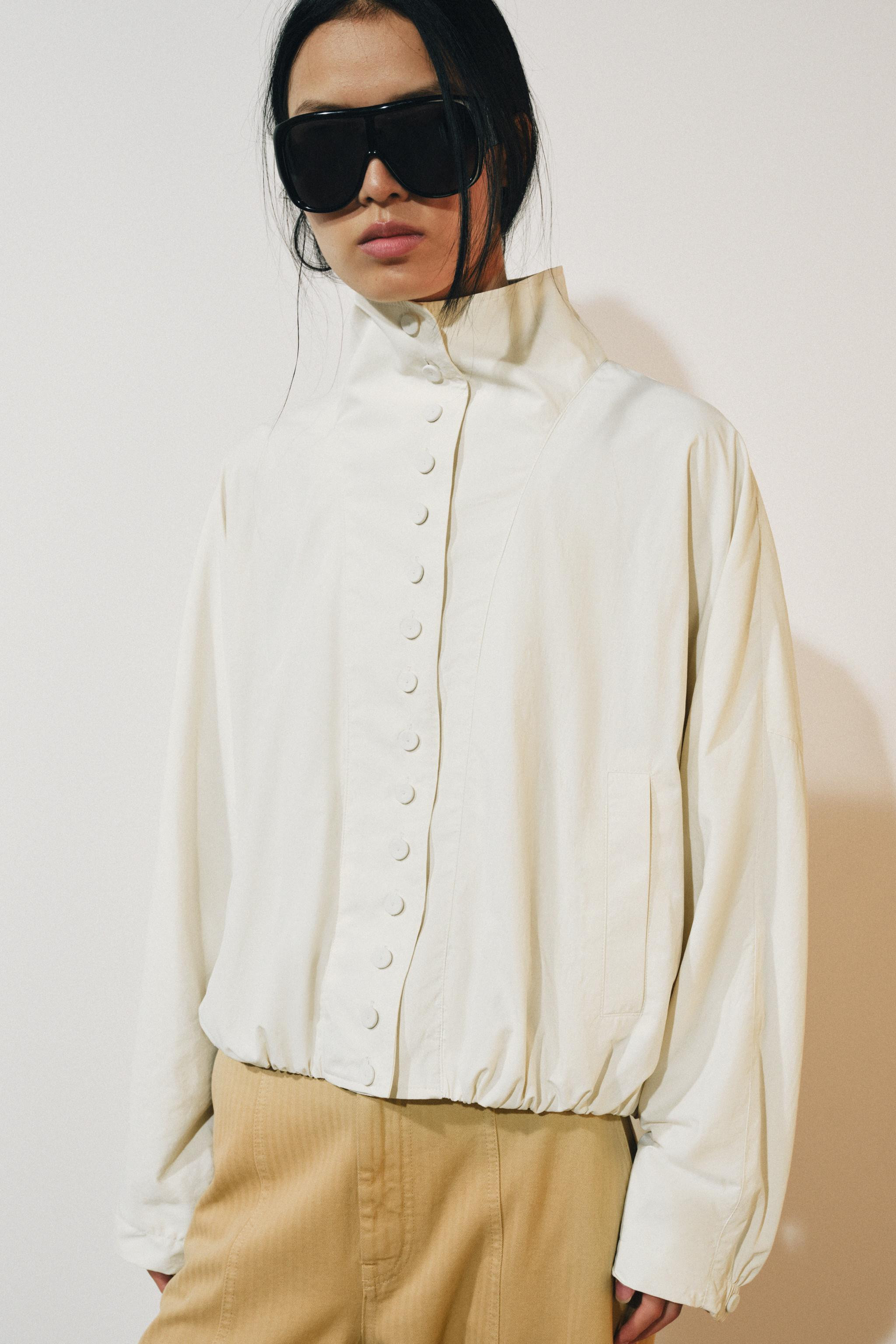 ZARA WOMAN COLLECTION. Jacket with a high neck and long sleeves. Front pockets. Straight, gathere... | Zara US