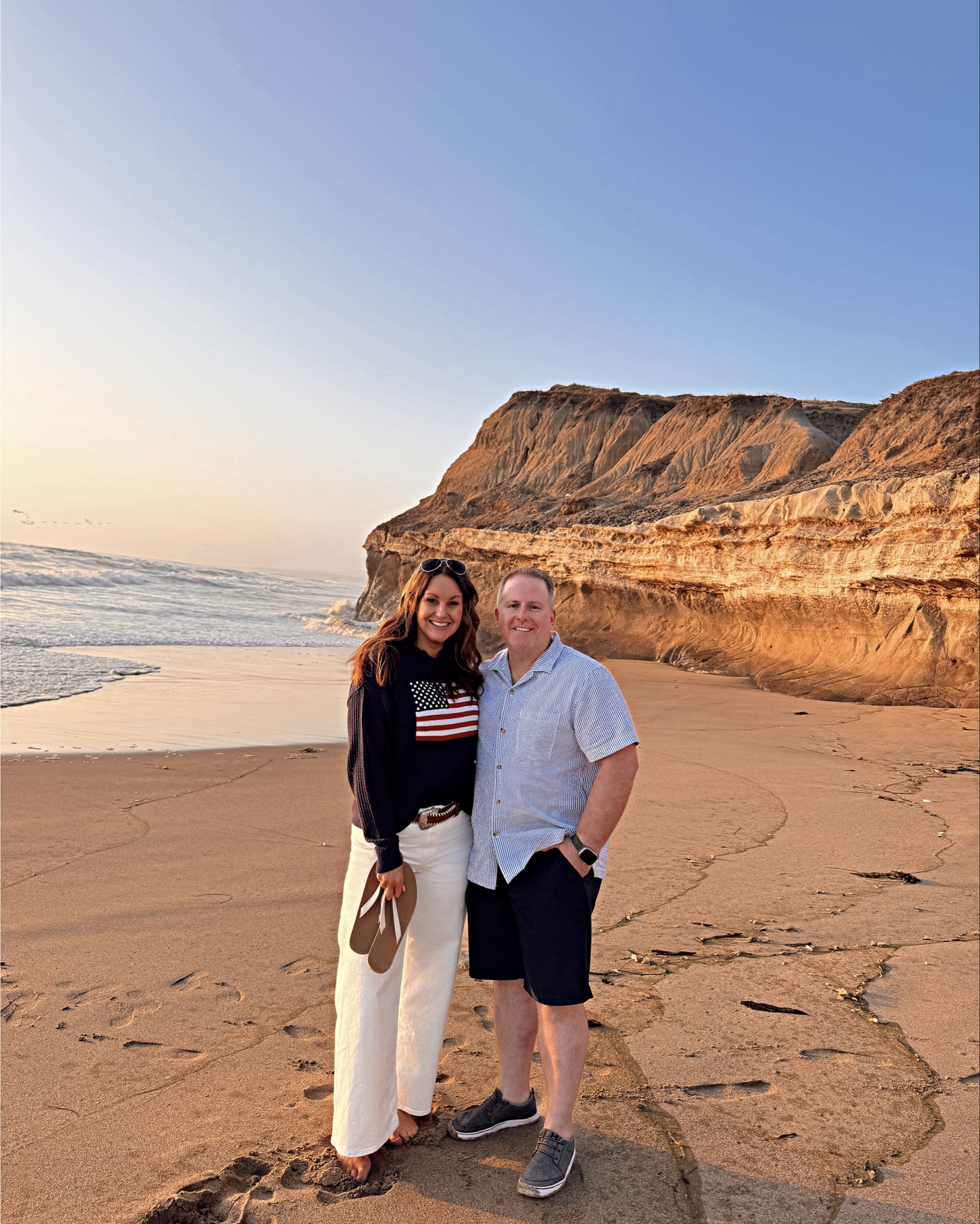 The quintessential coastal summer outfit 🇺🇸🌊
American Flag lightweight hoodie sweater paired with white Sailor Pants and sandals 
Hoodie Sweater: I upsized to XL for an oversized look. Available in navy or white
Sailor Pants: wearing my normal size 12. Available in multiple colors  (note: these pants do not have front pockets )

American Flag Sweater
Mini Bag

#LTKTravel #LTKSummerEdit #LTKMidsize