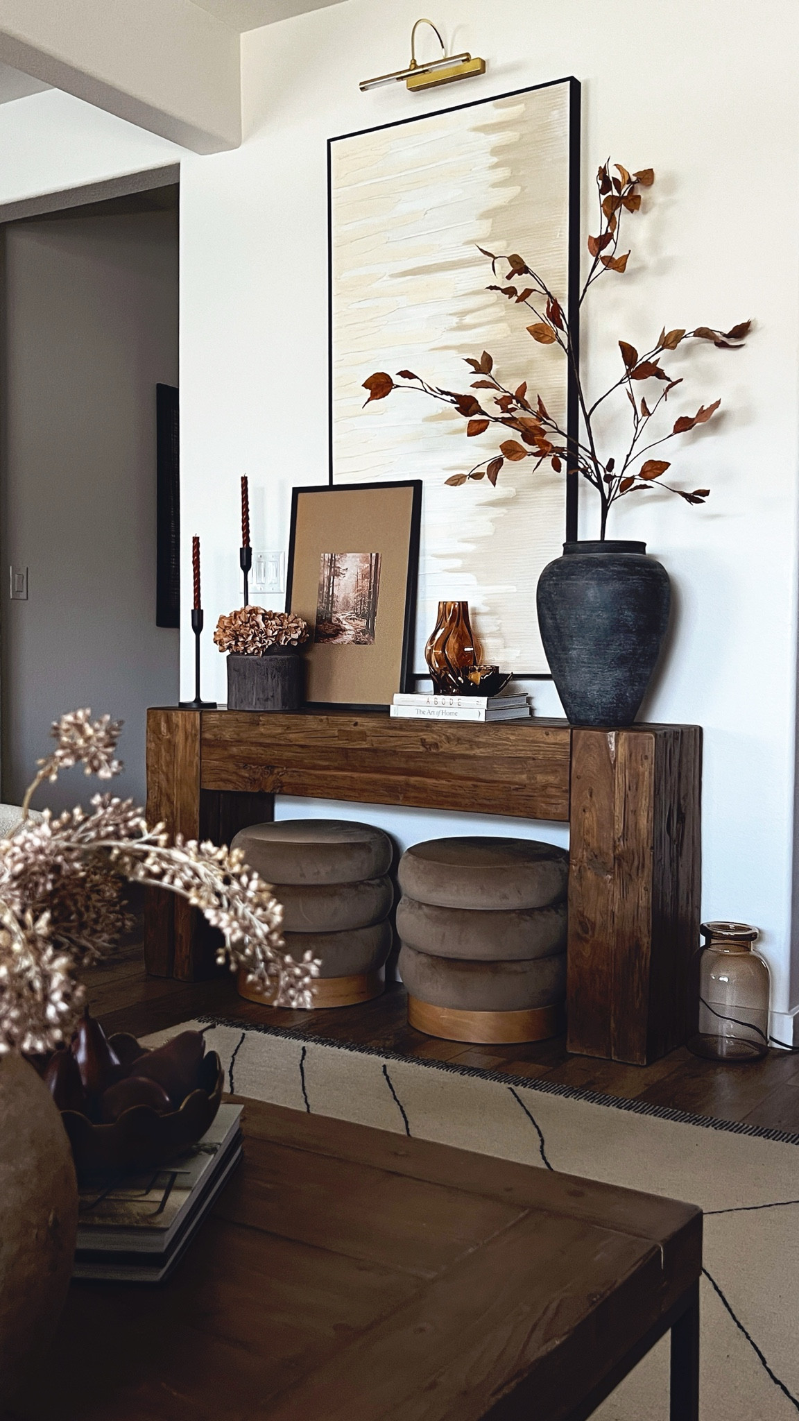 A fall-styled console table! Solid wood console table, coffee table books for fall, velvet brown Ottomans, large black vase, statement vase, brown hydrangeas, rust leaf stem, Amazon art prints, fall wall art, fall candles, fall vases

#LTKSeasonal #LTKHome