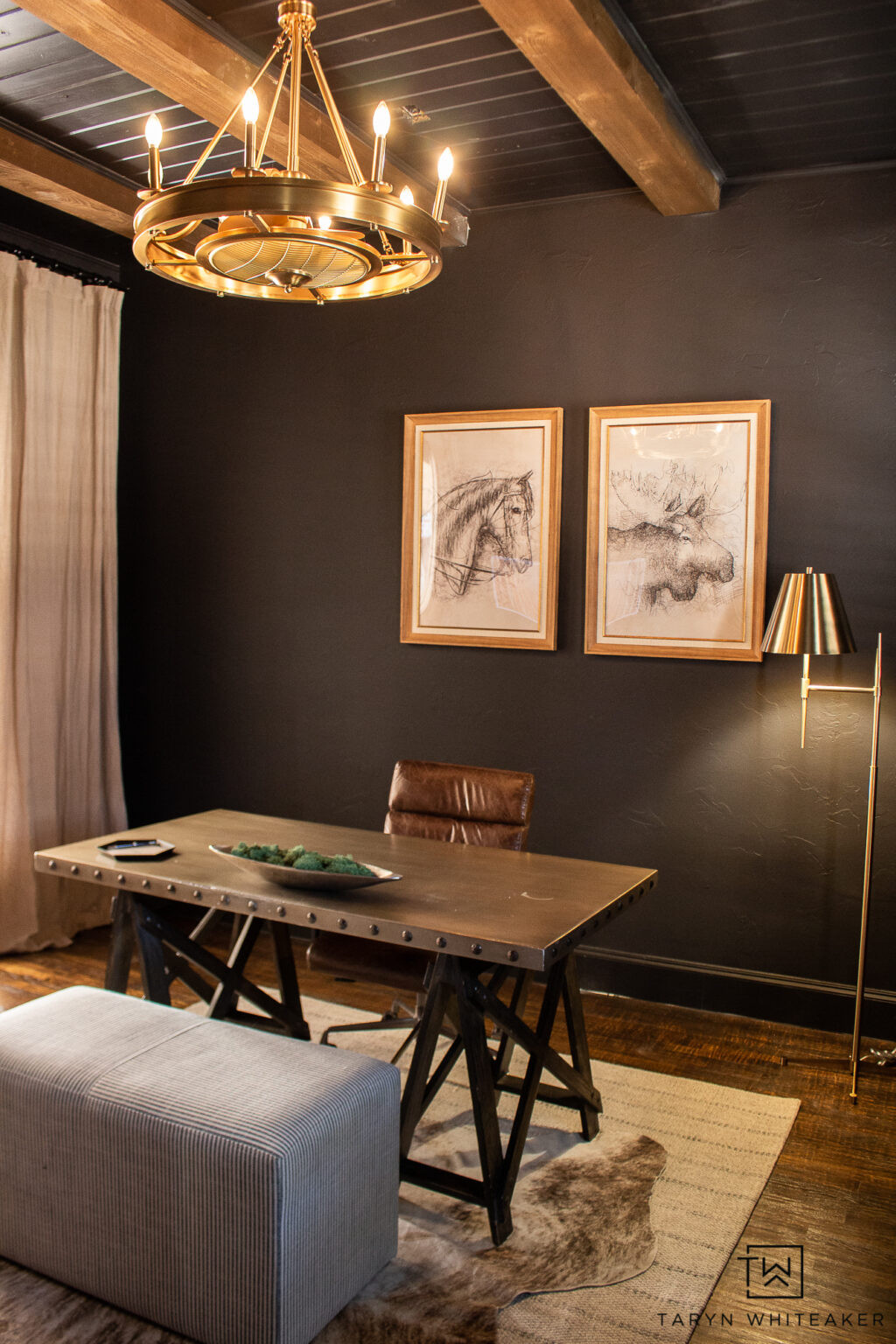 This office space is a reminder that dark walls can feel both cozy and refined. Warm wood tones, layered lighting, and simple artwork create a space that feels focused but still inviting. A home office that works hard during the day and feels styled enough to leave as-is.

home office decor, dark office walls, modern home office, moody office inspiration, office lighting ideas, neutral office decor, masculine home office, wood desk styling

#LTKHome #LTKdayinmylife #LTKSeasonal