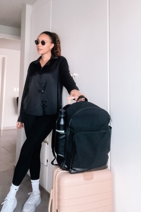 Travel OOTD, black high waisted leggings with pockets, satin button down shirt, comfy white sneakers, Béis luggage 

#LTKstyletip #LTKFind