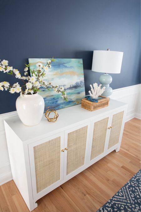 My white + cane coastal dining room buffet table is on sale for the lowest price I’ve seen in months! Shop all of the coastal decor that I own + love on sale for Memorial Day! 

#LTKfindsunder100 #LTKsalealert #LTKhome