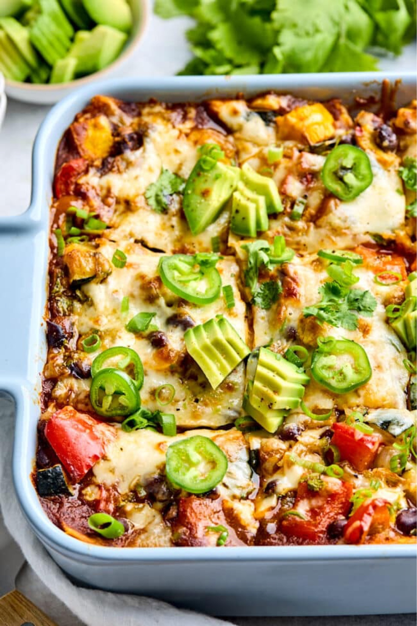 Stacked Vegetable Enchiladas- stacked enchiladas made with roasted vegetables, black beans, cheese, and enchilada sauce. These easy enchiladas are a family favorite and they are freezer friendly too! Full recipe on my blog at TwoPeasAndTheirPod.com

#LTKHome #LTKSeasonal