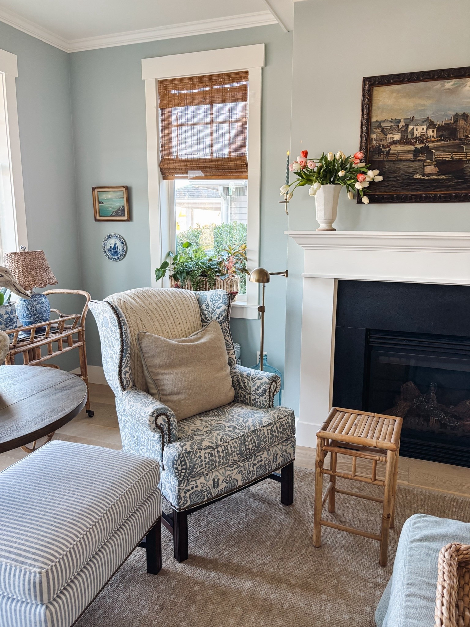 Spring living room sources - wingback living room chair, bamboo shades , tulips, rug, ottoman, blue chinos lamp with rattan scalloped lampshade and more 

#LTKHome #LTKdayinmylife #LTKSaleAlert