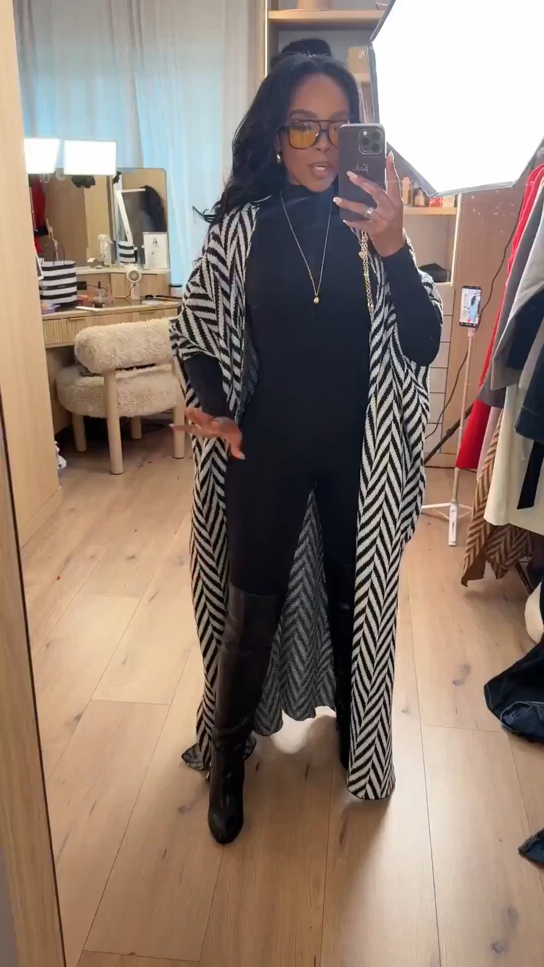 Polished layers with an edge — this is how I’m styling a fitted black base when I want warmth, shape, and contrast without overthinking it. The long patterned layer adds movement while the black underneath keeps everything grounded and wearable.

Perfect for coffee runs, casual meetings, travel days, or a chic everyday look.

Tap to get details and recreate this outfit.

📏 Sizing & fit details:  
Wearing size Small  
Height: 5’4”  
Bust: 34D  
Waist: 27”  
Hips: 40”  
Jeans and pants fit reference: 27 Long / 4 Long  

This look works because the fitted base balances the dramatic outer layer, making it easy to style with boots now and lighter shoes later. Pieces like this are great building blocks you can rewear all season, styled multiple ways so the cost per wear keeps dropping.

Neutral layered outfit ideas, black base outfit styling, winter layering inspiration, everyday chic outfits, versatile capsule wardrobe pieces, long coat styling, wide-leg pant alternatives, modern casual looks.

Follow me on Instagram and YouTube @kirasfashionfinds 

