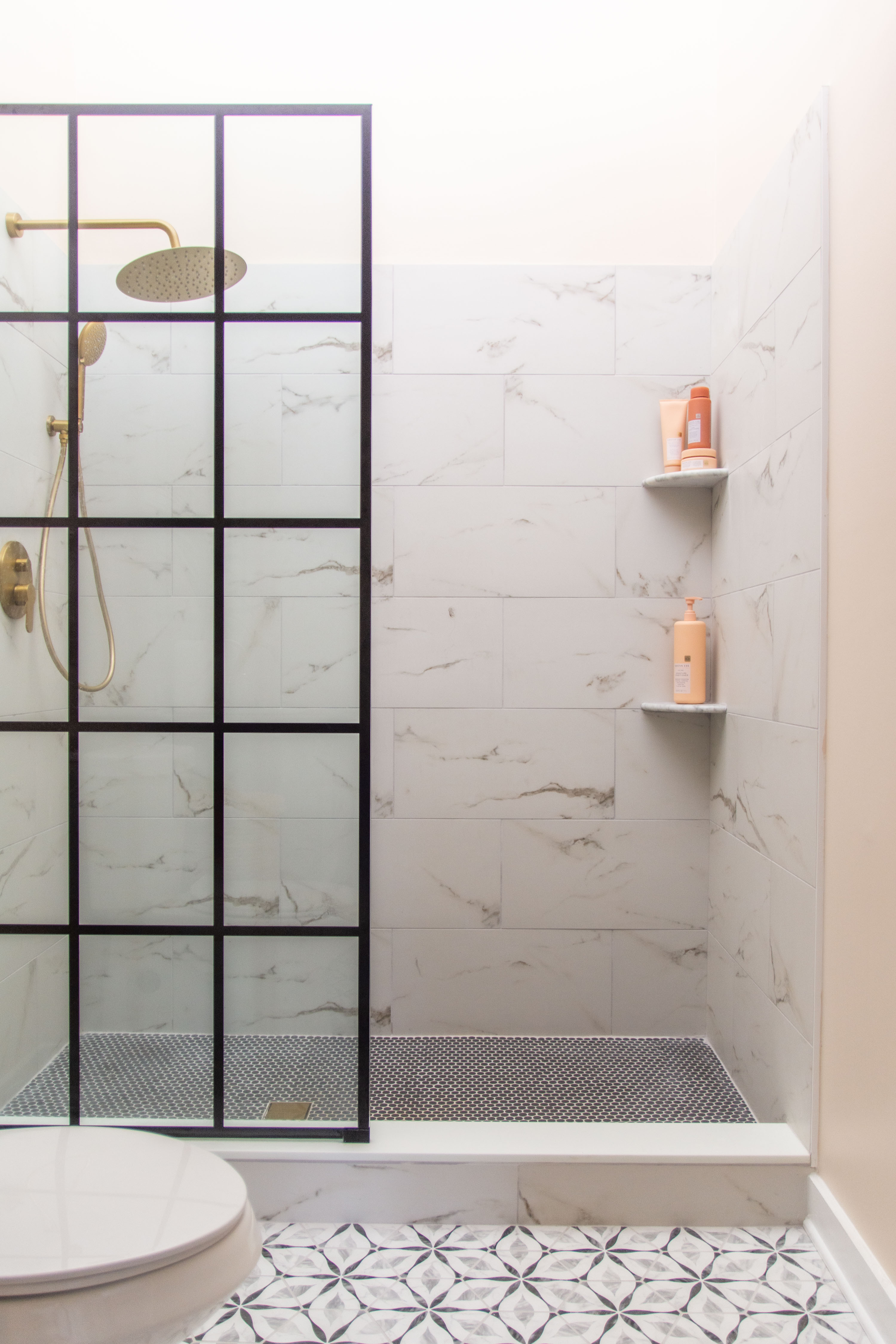 Iron paned glass shower door, shower wall for walk-in shower, marble porcelain wall tiles, ceramic marble look tiles, gold shower faucet, brass shower fixture, bathroom design ideas, bathroom renovation tips 

#LTKHome #LTKStyleTip