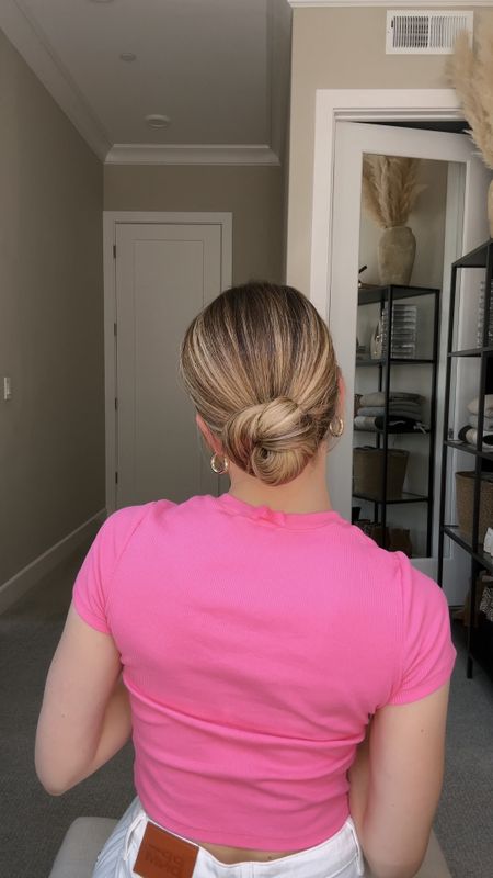 10 Second Low Bun 💁‍♀️

Gather hair into a low ponytail and hold it with your dominate hand. Pull hair tie over ponytail just enough to create a mini loop. Place non-dominate hand inside elastic as you swoop the hand under the ponytail. Drive hand counter-clockwise as you collect the ponytail onto the elastic. Twist one time. Place elastic (currently wrapped with hair) over the mini loop you created in the first step. Voila! She’s cute and put together in less than 10 seconds.