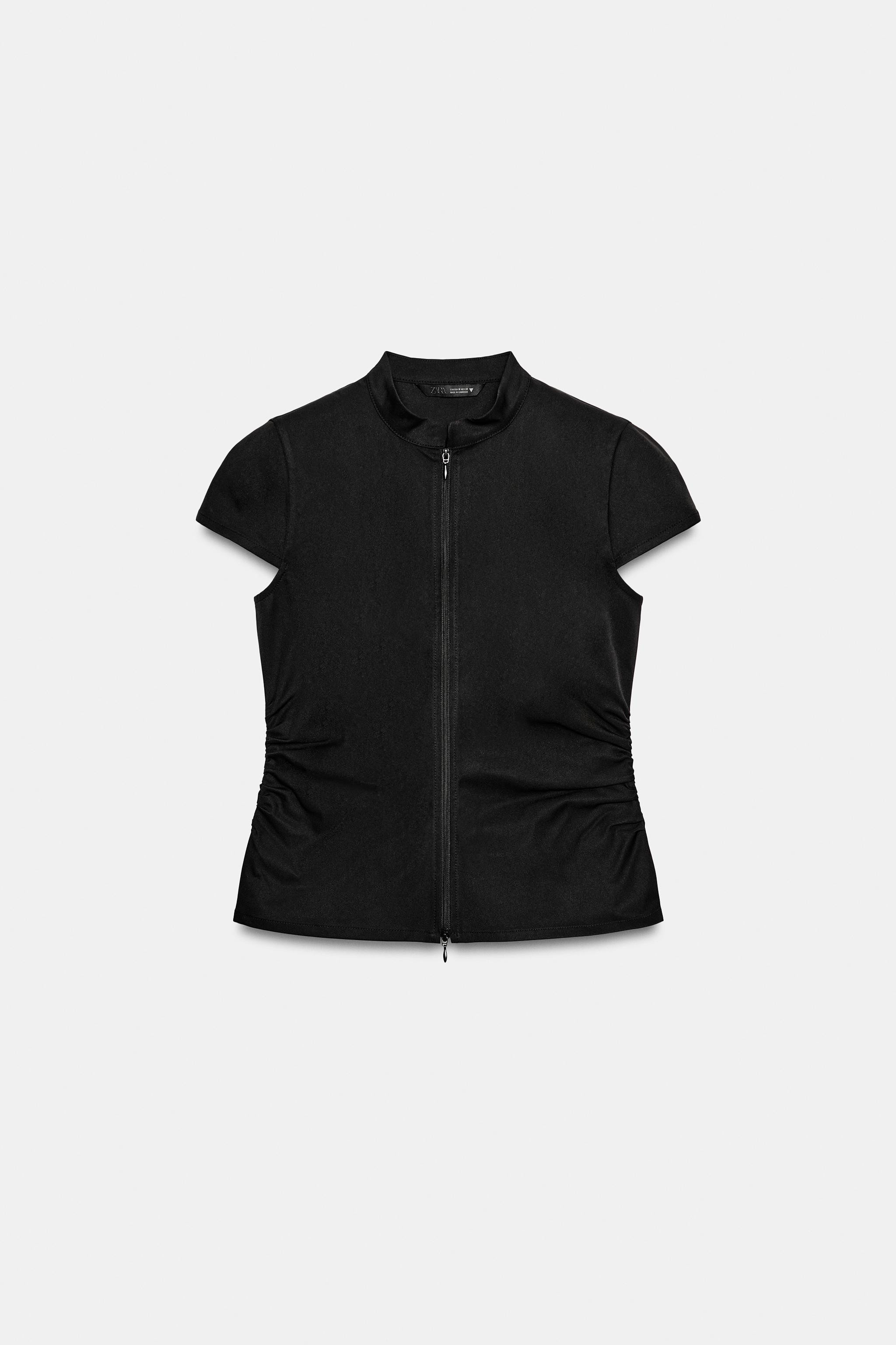 Model height: 181 cmHigh-neck, short-sleeve top. Featuring side gathering detail and a front zip ... | Zara UK