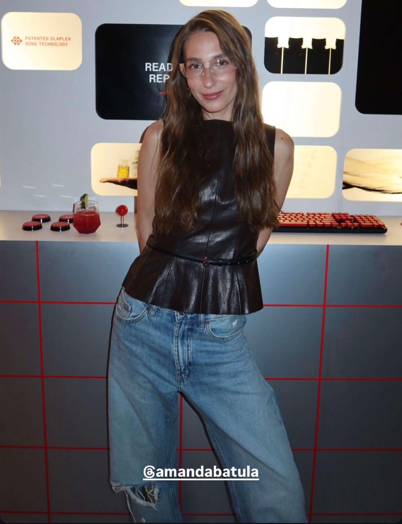 Shop Amanda Batula's  under $50 faux leather sleeveless plum belted top ￼