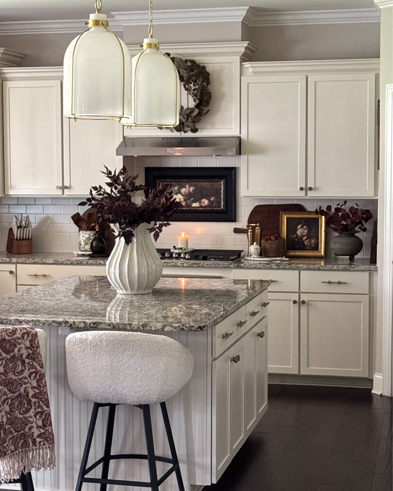 Friday Photos of my Soft Kitchen!! Less like a workspace and more like a cozy lived-in room🤎

Burgundy wreath, vintage inspired floral print, burgundy floral throw blanket, fluted cream vase, black vase, plum stems, burgundy eucalyptus, brass salt & pepper grinders, round marble board, marble bowl with lid, vintage wood bowl, vintage cutting board, dried pomegranates, island stool, island pendants, green floral crock, rechargeable lamp, black serving board, wood utensils, green olive oil bottle, gold pourers 

#LTKstorytime #LTKSeasonal #LTKHome