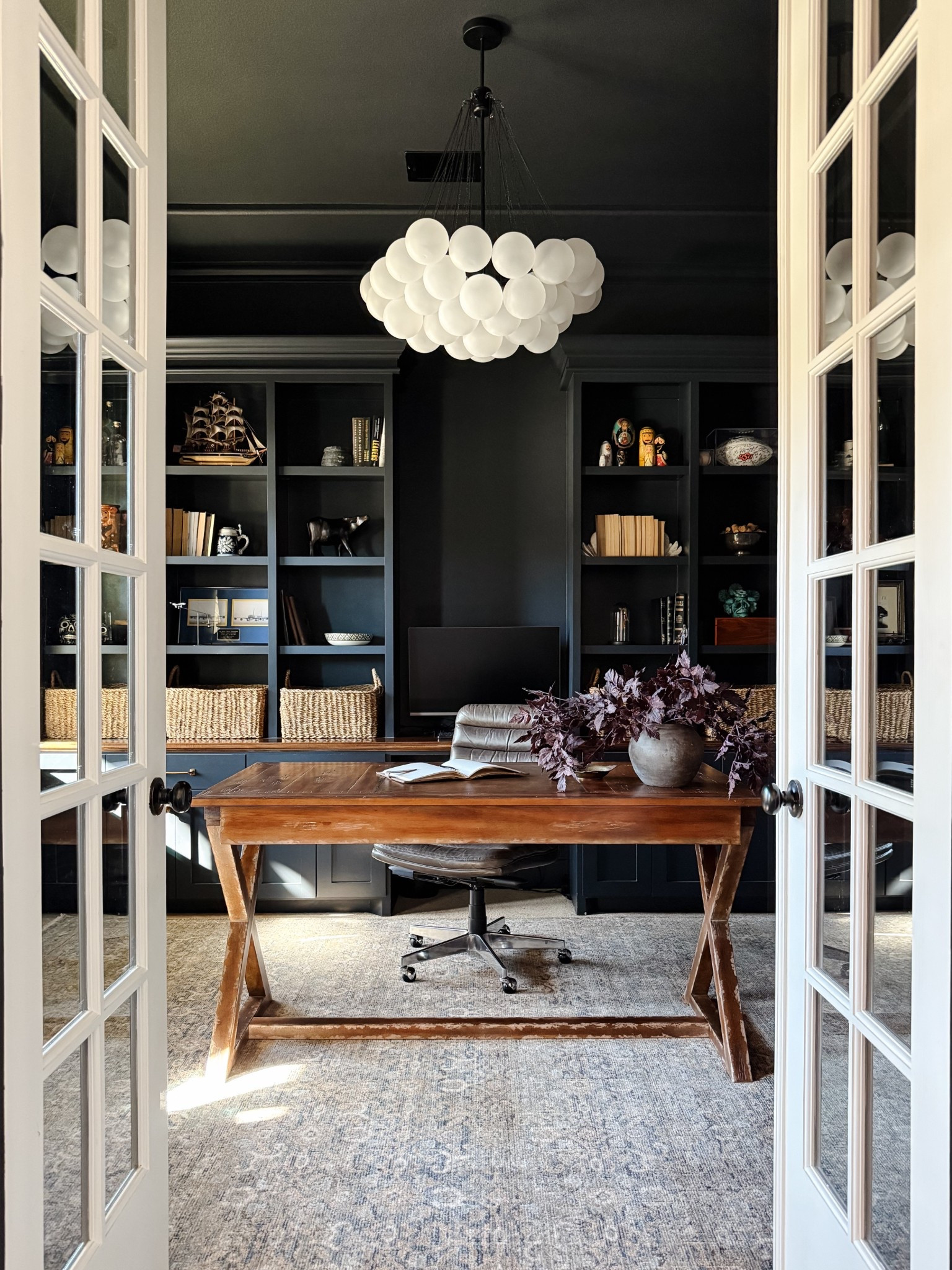 Our moody home office with vintage inspired rug, cluster chandelier, and wood desk



#LTKHome