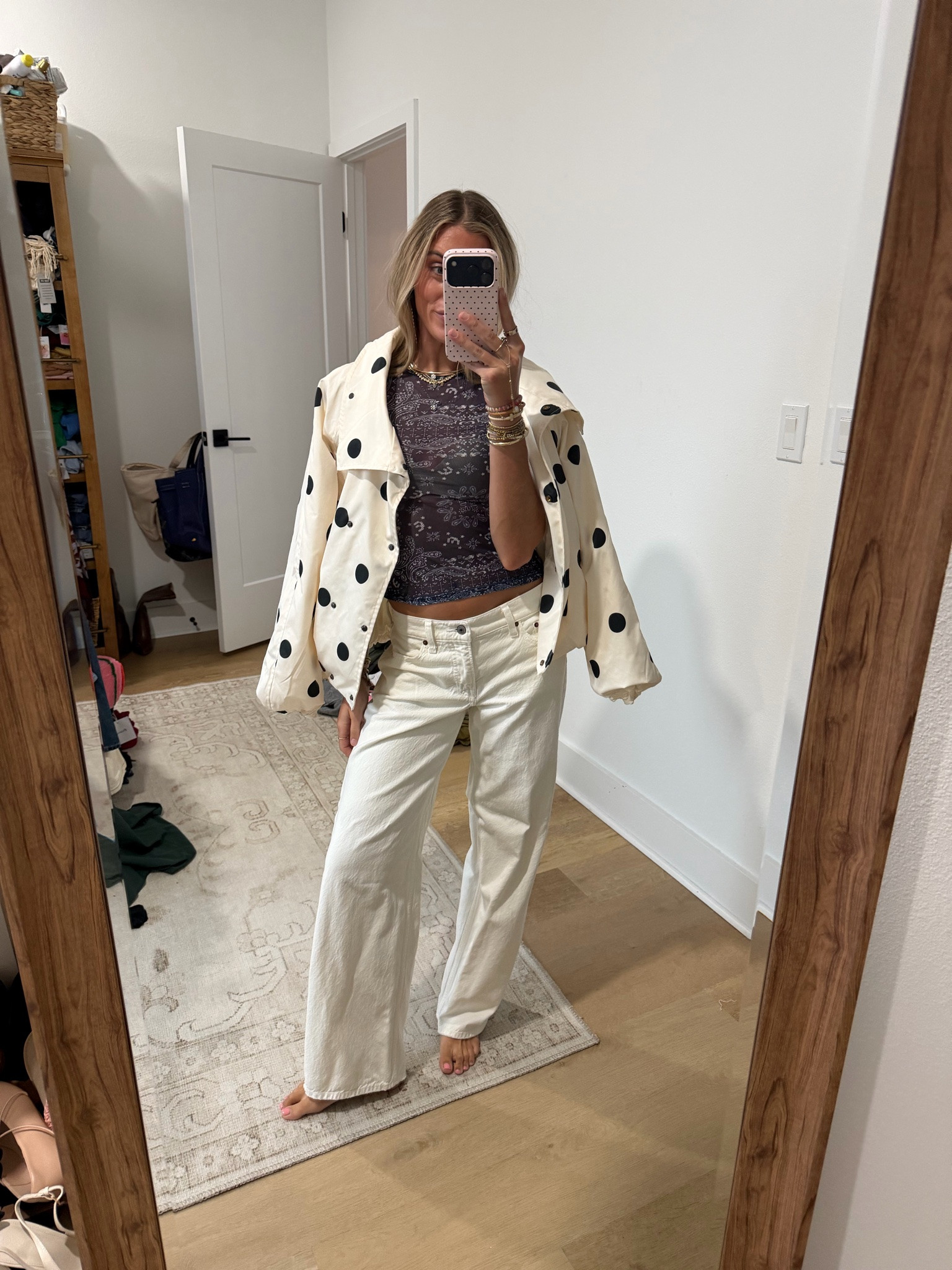 rainy and gross so gotta bring some fun with the outfit I’m wearing my @abercrombie low rise loose white jeans paired with my new @renttherunway miaou mesh short sleeve tee with the skims wireless bra and my polka dot amazon windbreaker jacket