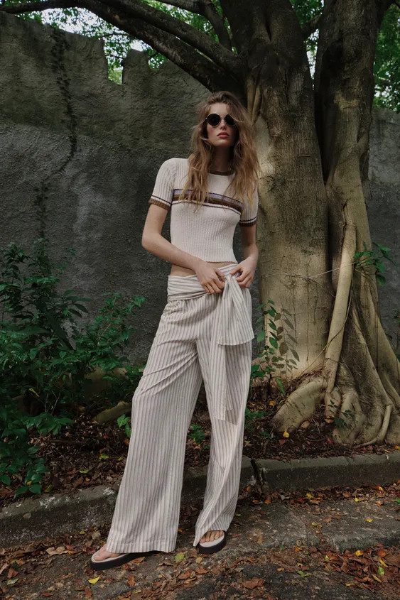 Top made from rustic-style fabric. Featuring a round neck and short sleeves. With contrasting str... | Zara UK