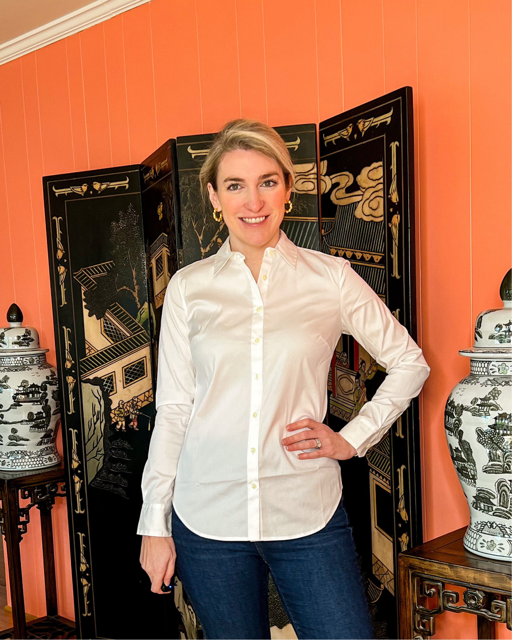 There’s darting at the bust and in the back for a more slim fit. Because of the fit, this shirt is ideal for wearing under blazers or sweaters. True to size.