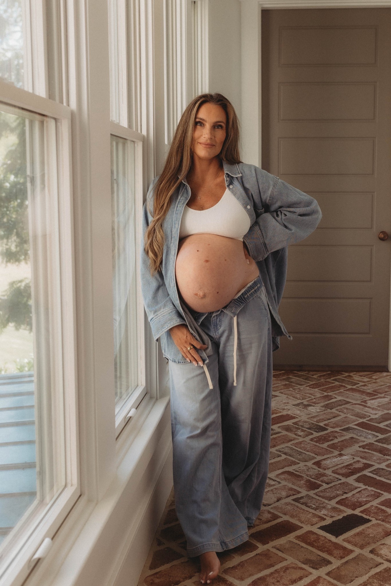 Maternity photos for third trimester. Denim on denim look for the growing bump. Wearing my fave sports bra that’s so soft with my drawstring wide leg jeans. Everything is on sale  

#LTKBump #LTKFindsUnder50 #LTKSaleAlert